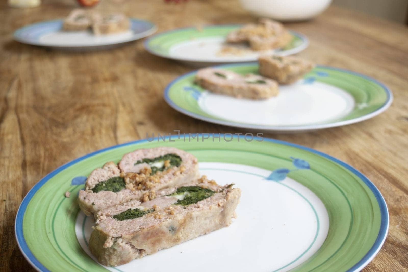 plates lined up with spinach meatloaf inside