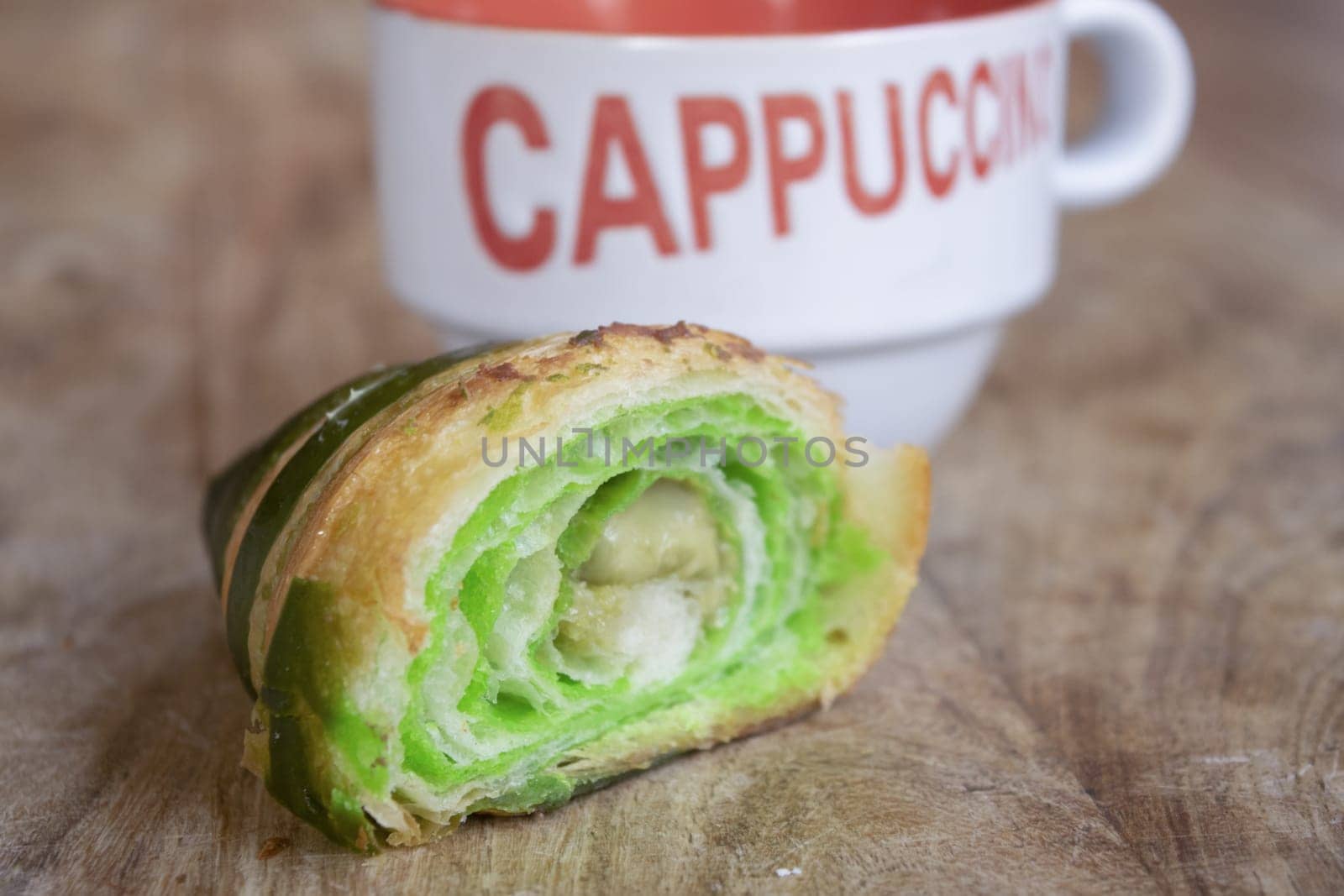 morning awakening with cappuccino and half pistachio croissant