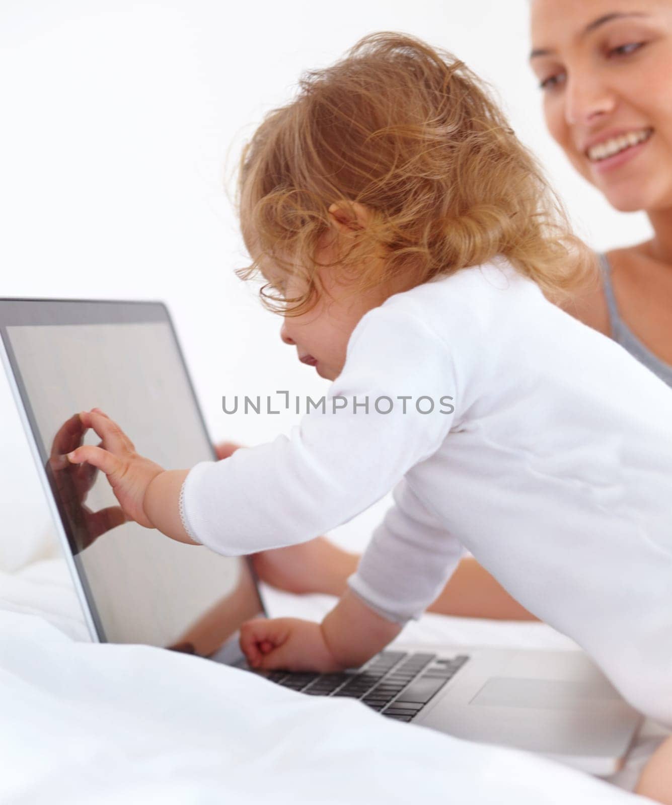 Baby, learning and mom with laptop in home with cartoon, movies or games for education. Infant, kid and mother with computer in bedroom for child development, growth and website for teaching by YuriArcurs