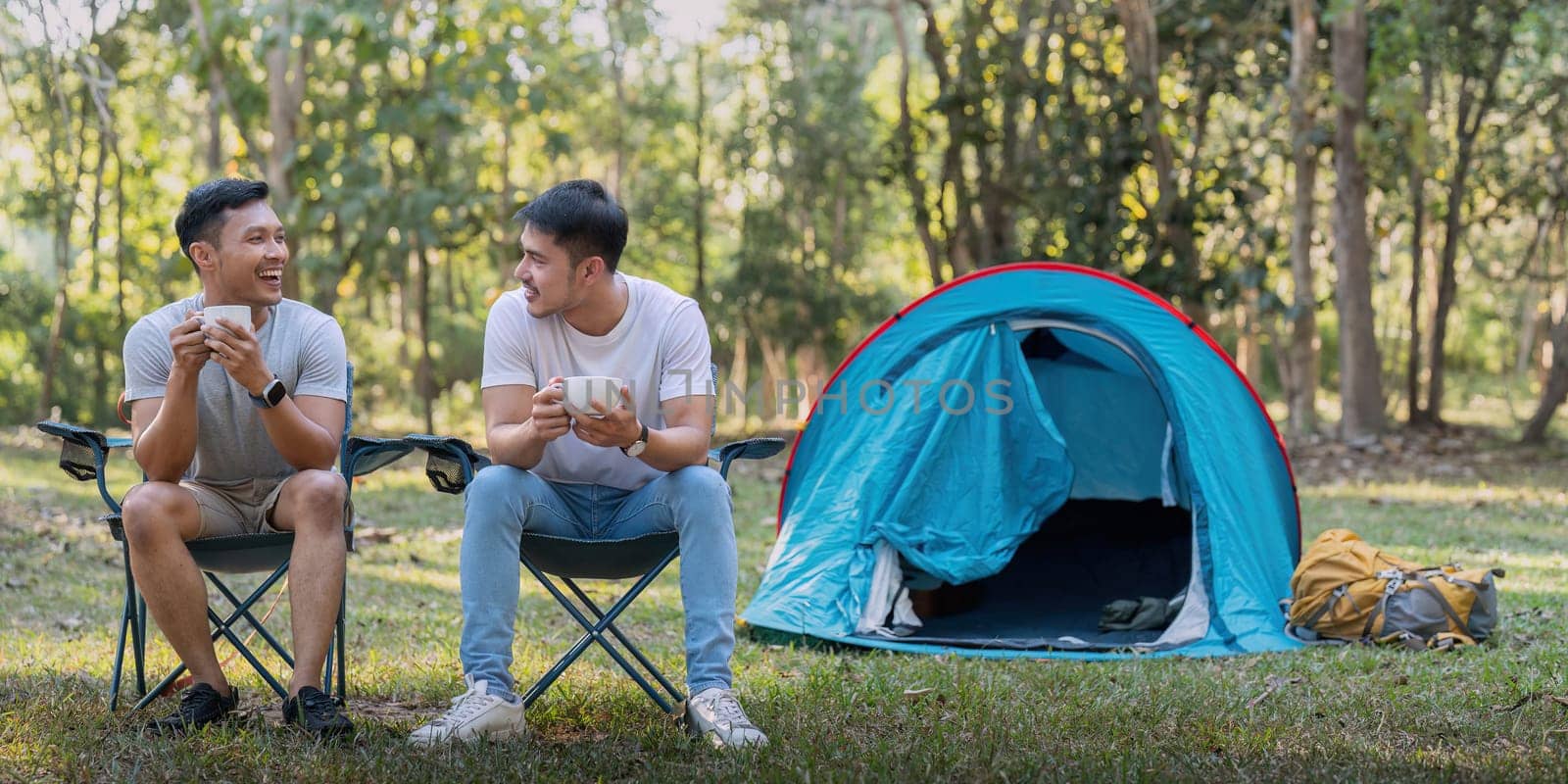 Male gay couple asian traveling with tent camping outdoor and various adventure lifestyle hiking active summer vacation.