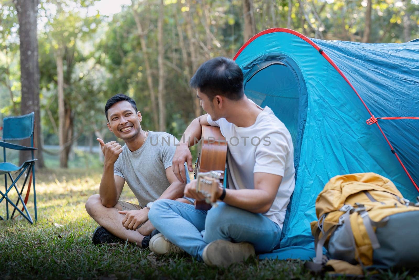 Male gay couple asian traveling with tent camping outdoor and various adventure lifestyle hiking active summer vacation by nateemee