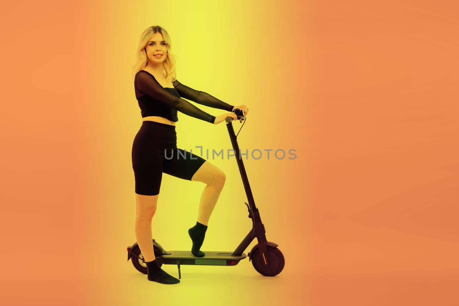 Female in sport clothes stands on electric scooter with sunglasses on red and white background by Zelenin