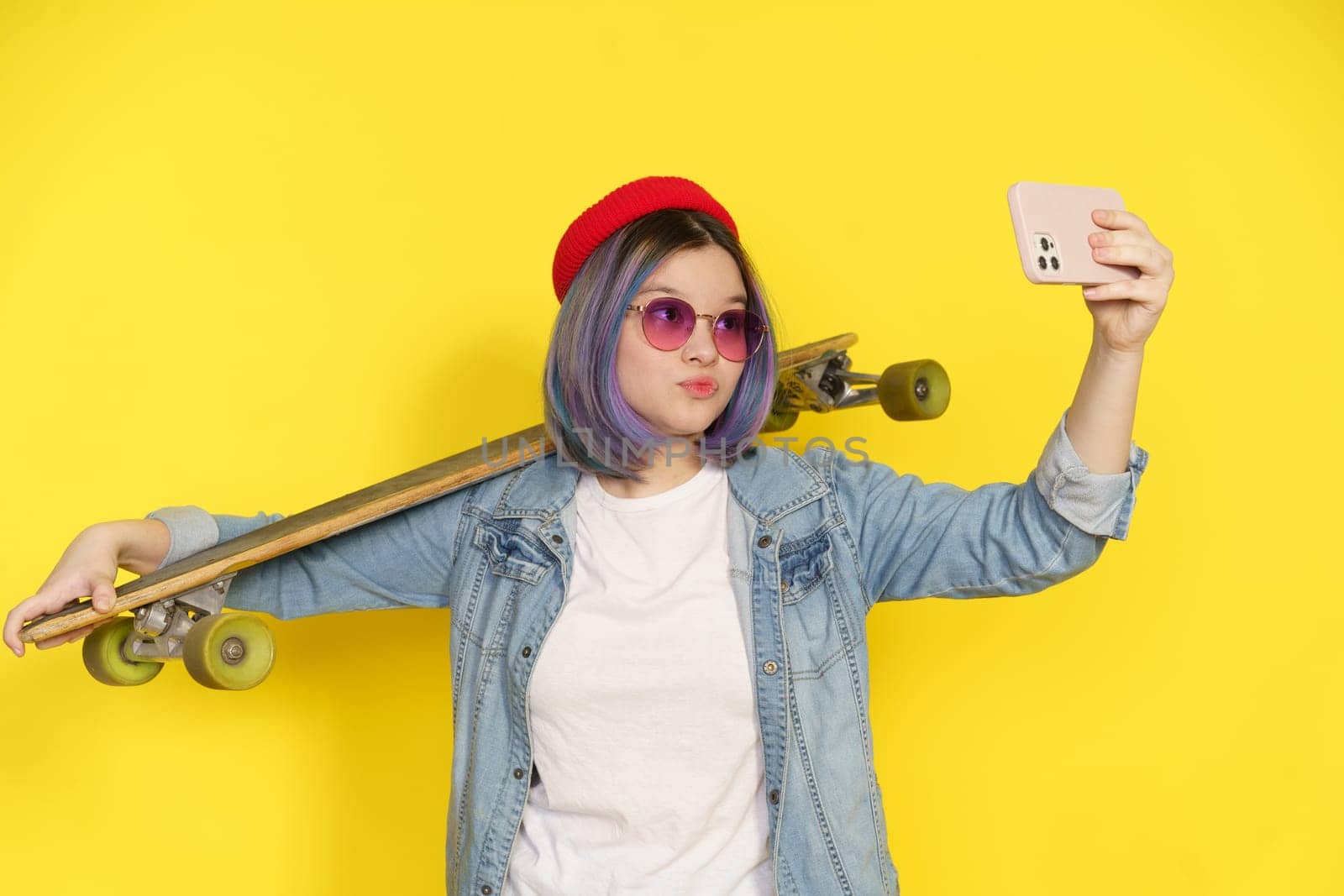 Trendy Teenager In Casual Wear Captures Selfie With Longboard Or Skateboard, Showcasing Blend Of Modern Lifestyle, Fashion, And Youth Culture. Trendy Attire And Activities Associated With Contemporary Teenagers. High quality photo