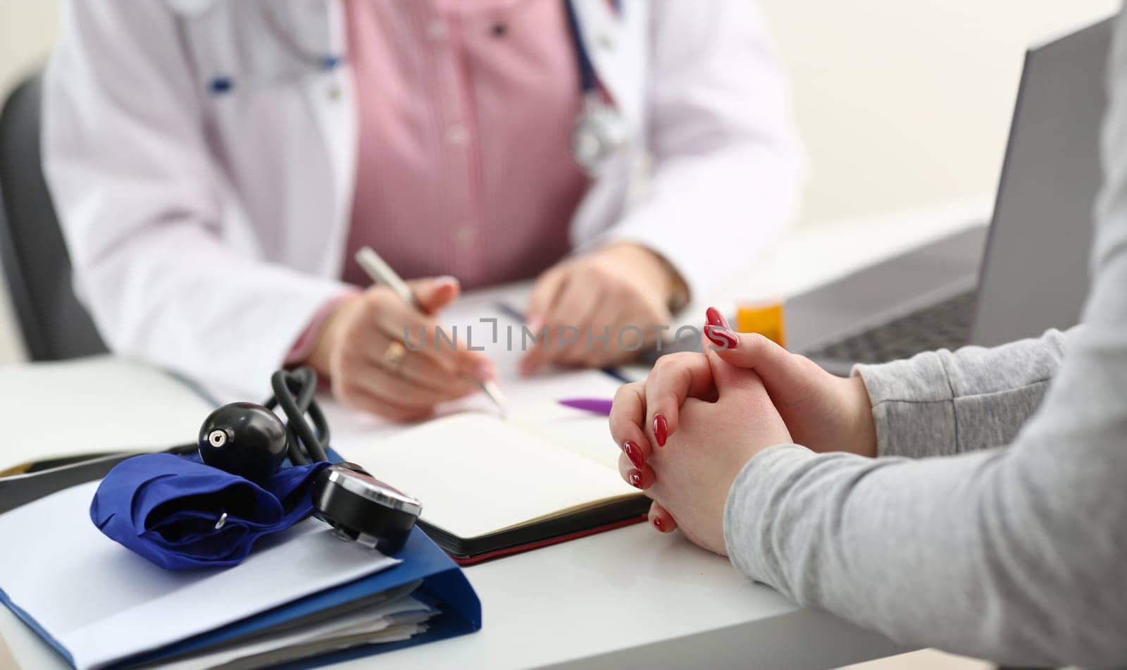 Female doctor hand hold silver pen filling patient history list at clipboard pad. Physical exam er disease prevention ward round visit check 911 prescribe remedy healthy lifestyle concept