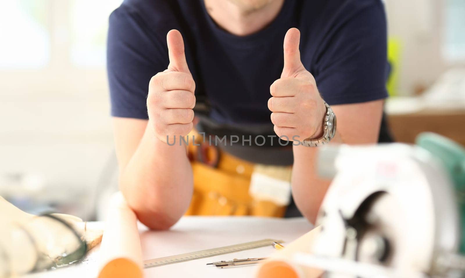 Arm of worker show confirm sign with thumb up closeup. Manual job DIY inspiration joinery startup idea fix shop hard hat industrial education profession career concept