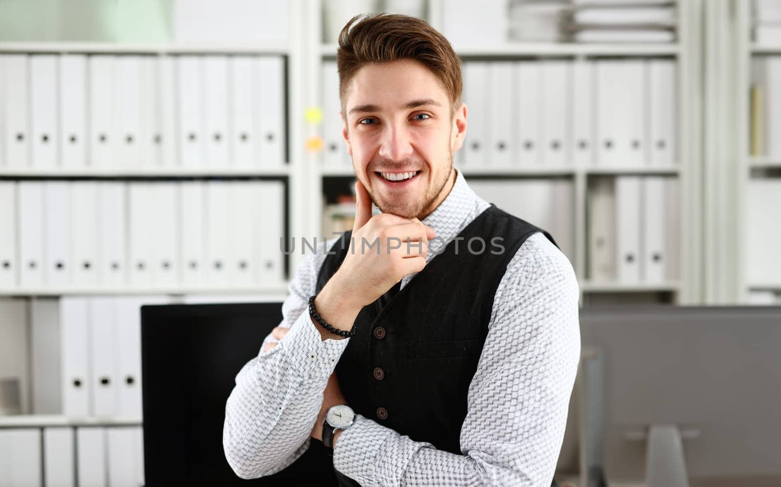 Handsome man in suit and tie stand in office looking in camera hands crossed on chest. White collar dress code modern office lifestyle graduate college study profession idea coach train concept