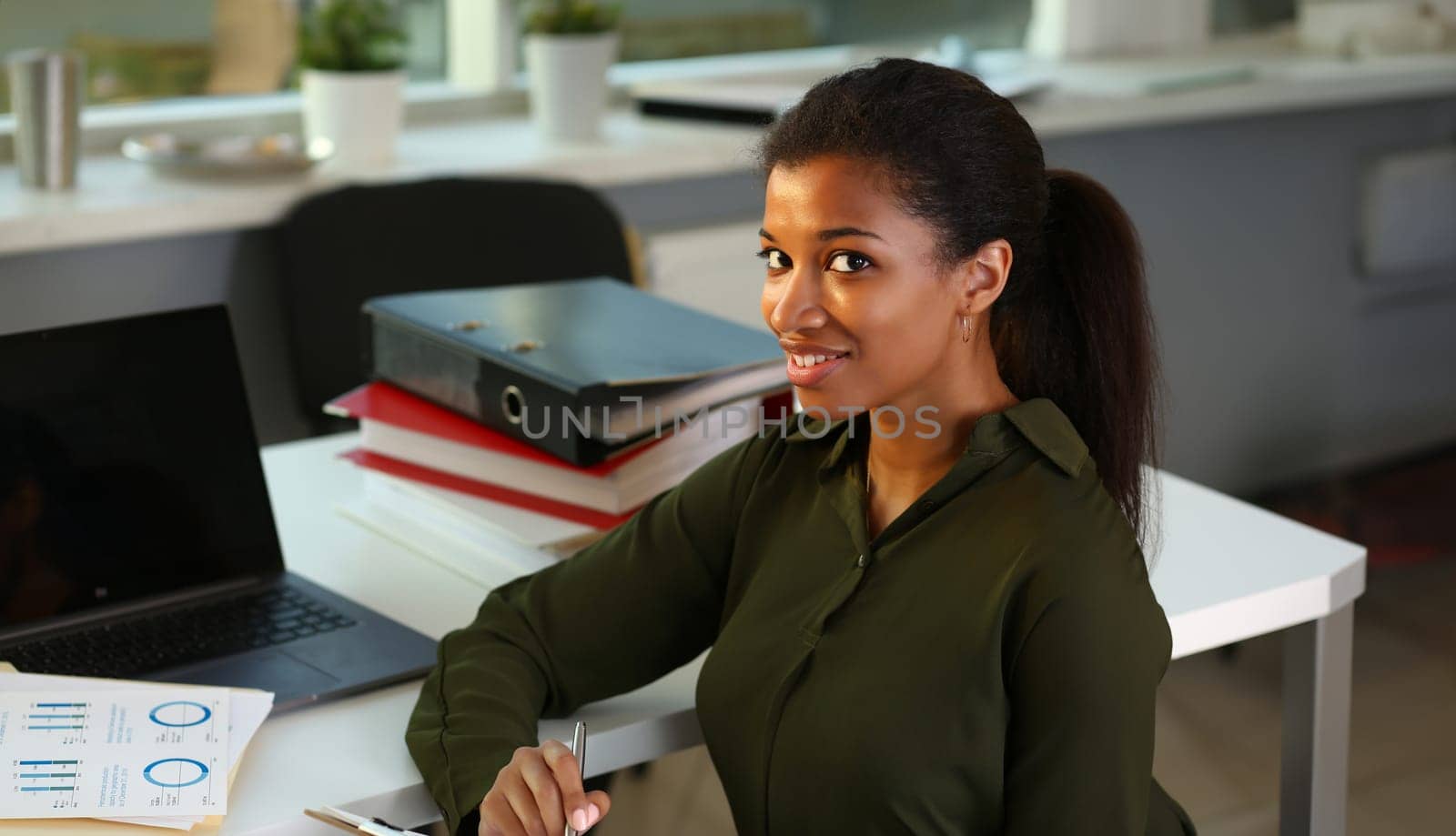 Beautiful black smiling businesswoman portrait at workplace look in camera. White collar worker at workspace exchange market job offer certified public accountant internal revenue officer concept