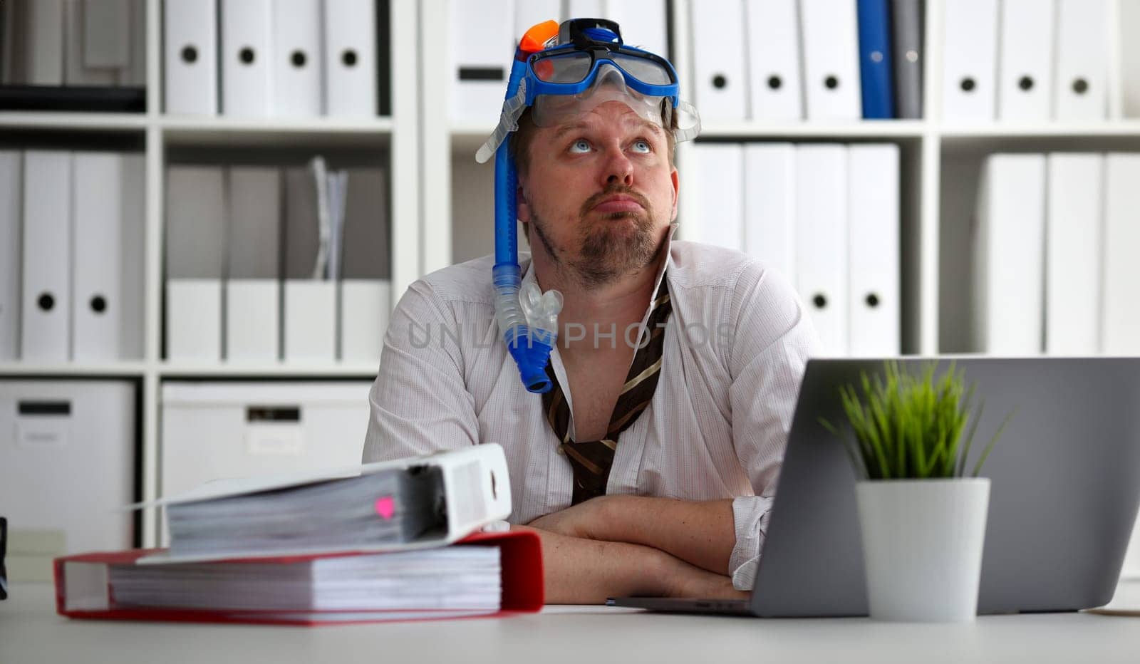 Man wearing suit and tie in goggles with snorkel sit at office workplace ready to take off portrait. Count days to leave annual day off workaholic freedom fun tourism resort idea concept
