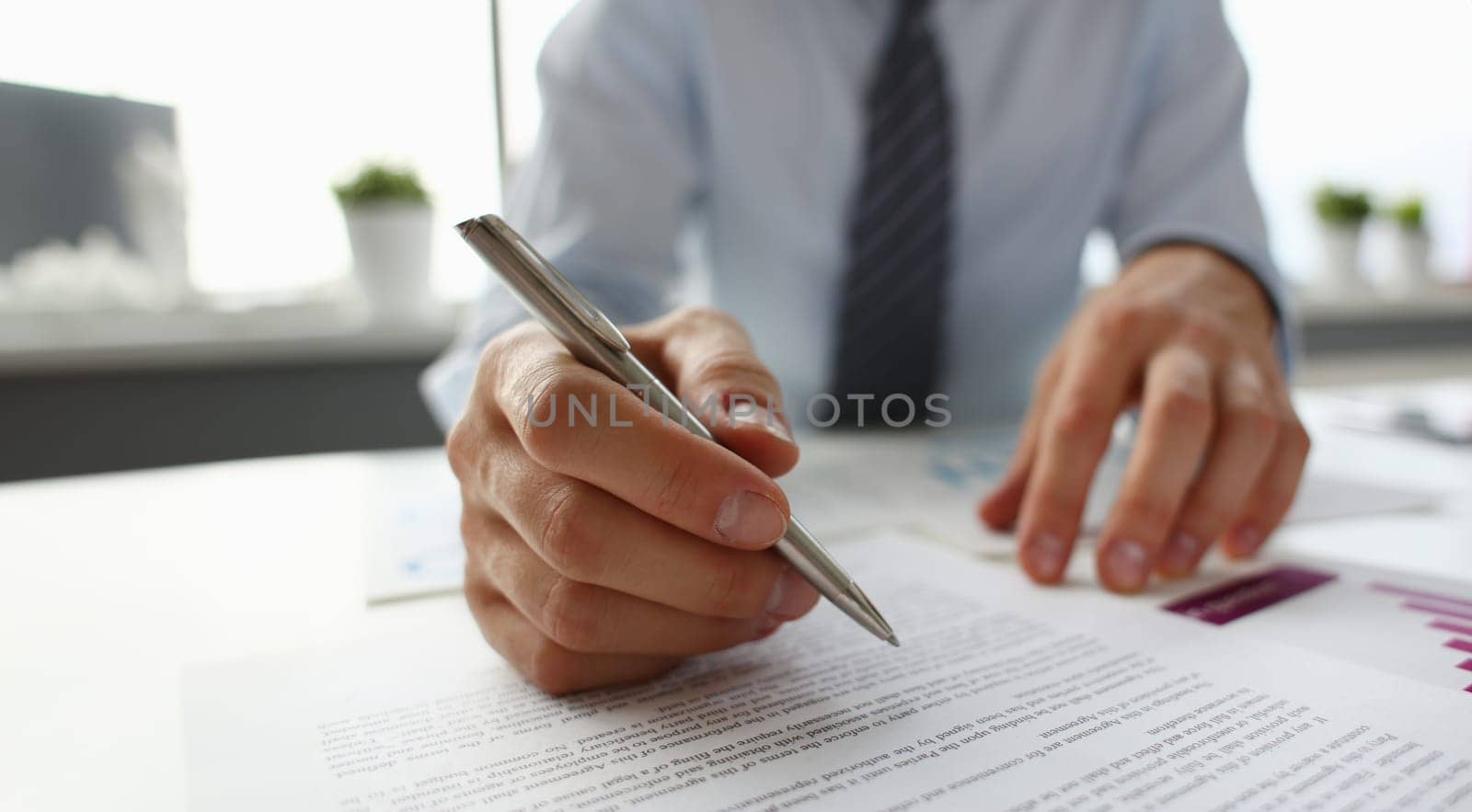 Hand of businessman in suit filling and signing with by kuprevich