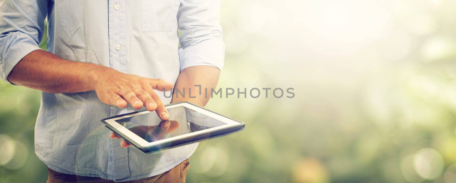 Tablet, person and internet connection in outdoors, technology and online research by bokeh. Mockup space, nature and networking or digital application, website and contact or online conversation by YuriArcurs