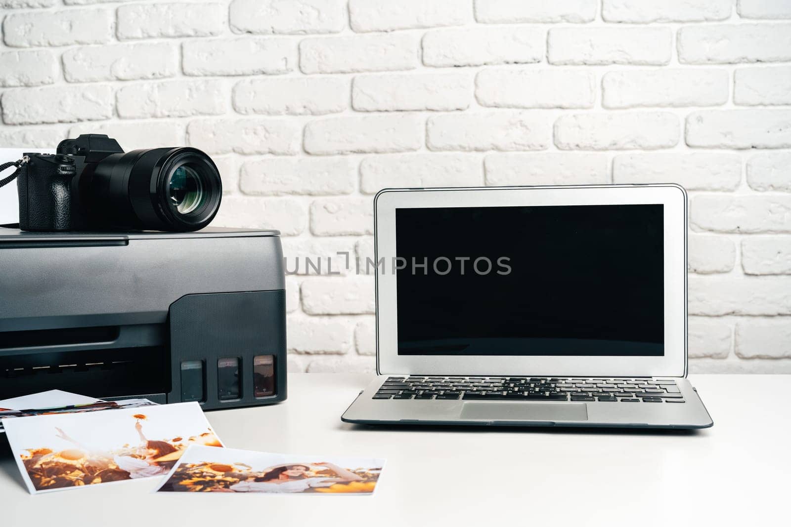 Printer, laptop and camera on table close up. Printing photos by Fabrikasimf