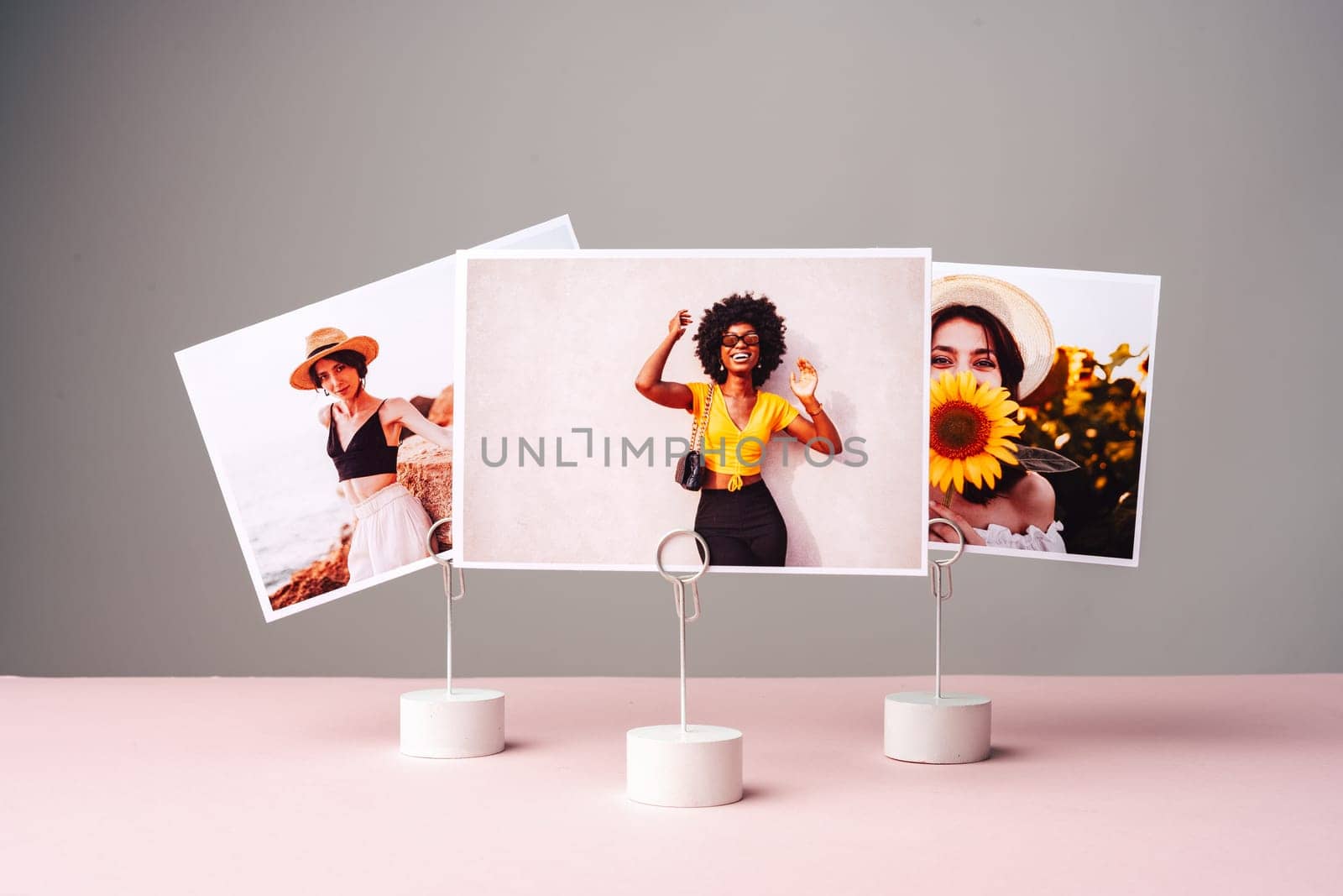 Printed colorful photos of women portraits against gray background by Fabrikasimf