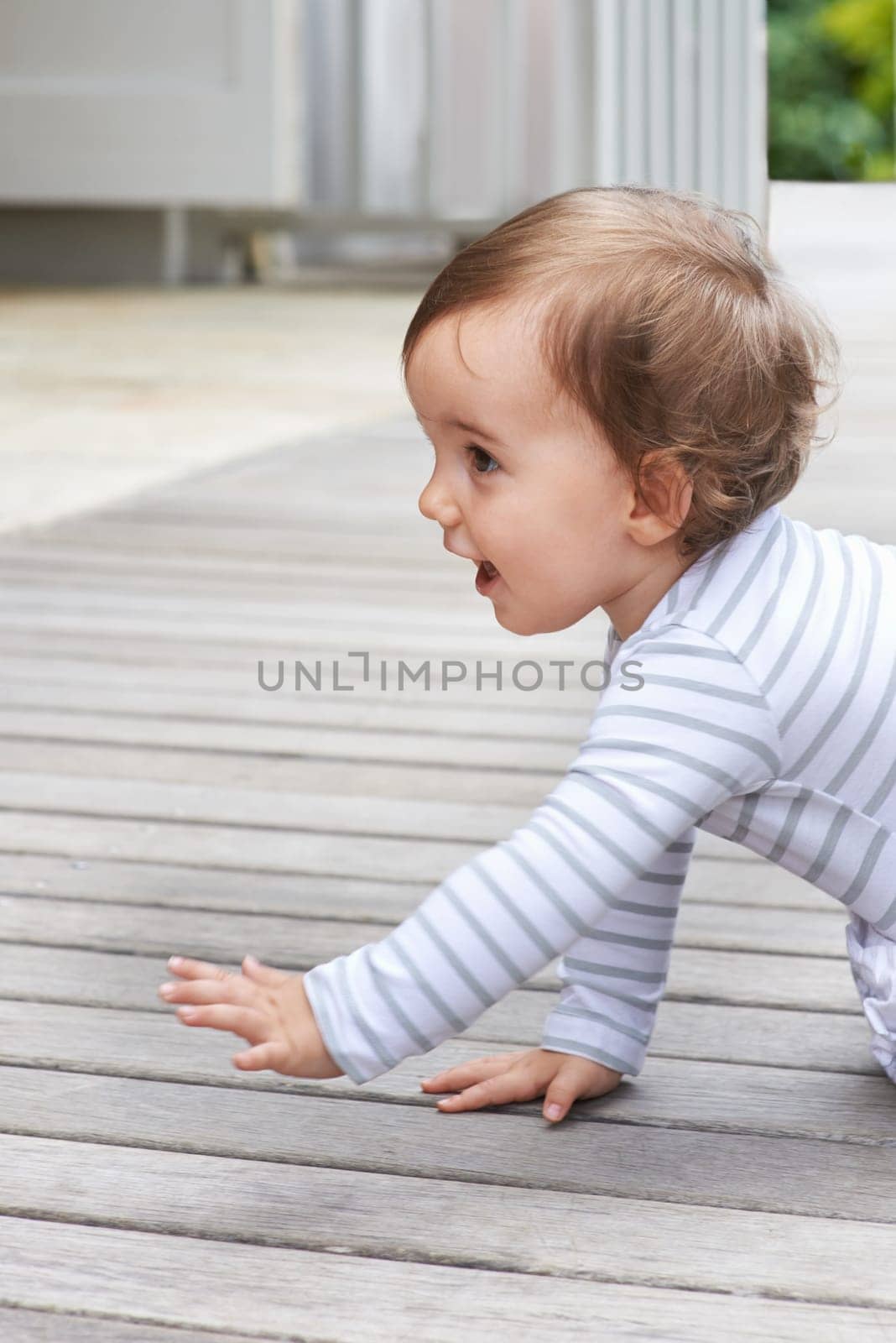 Baby, crawling outdoor and happy on floor, child development and growth with sensory, coordination and home. Girl, playing and healthy in good mood, childhood or balance with arms, kid or curious by YuriArcurs
