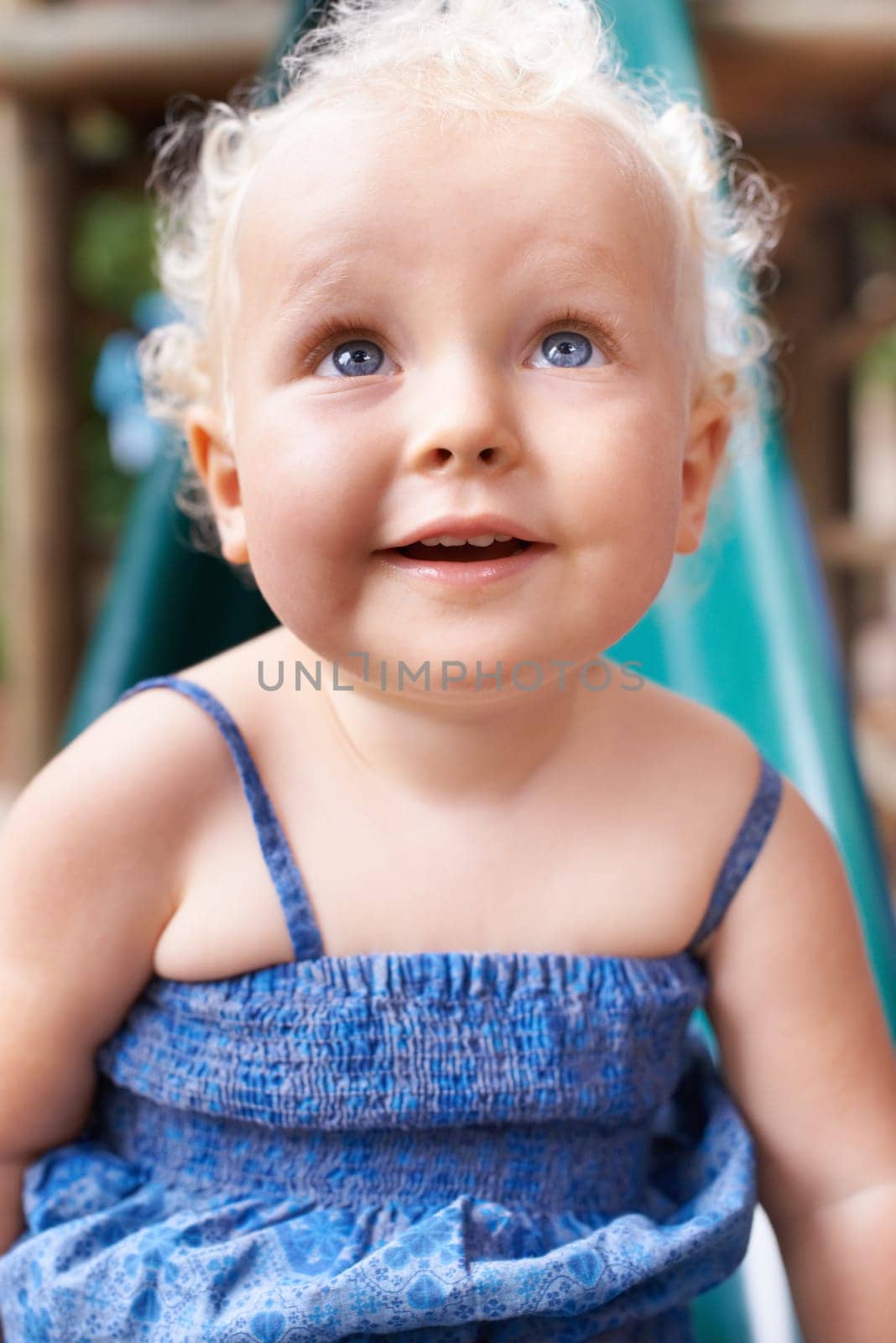 Baby, girl and child in home, happy and healthy kid alone in her house or kindergarten nursery. Face, cute blonde toddler and smile while playing, adorable and innocent facial expression of childhood.