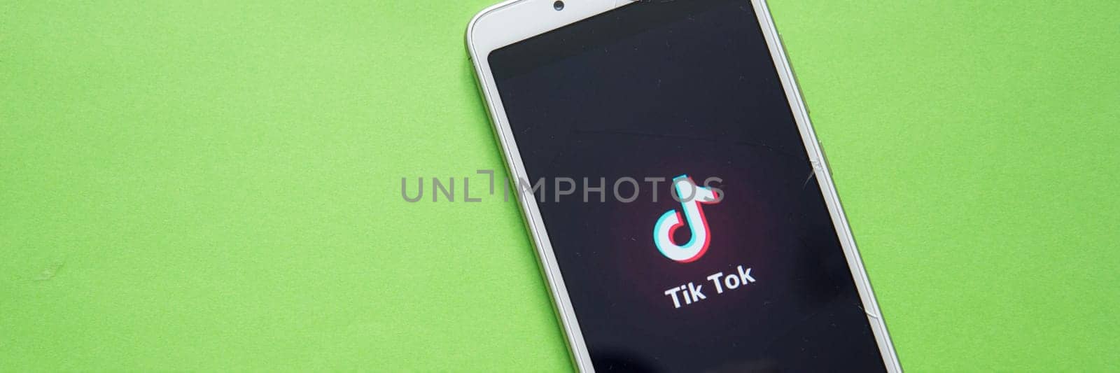Tver, Russia - February 12, 2020 Tik tok logo on smartphone screen on green background. Tik Tok icon. tik tok application. Tiktok Social media network