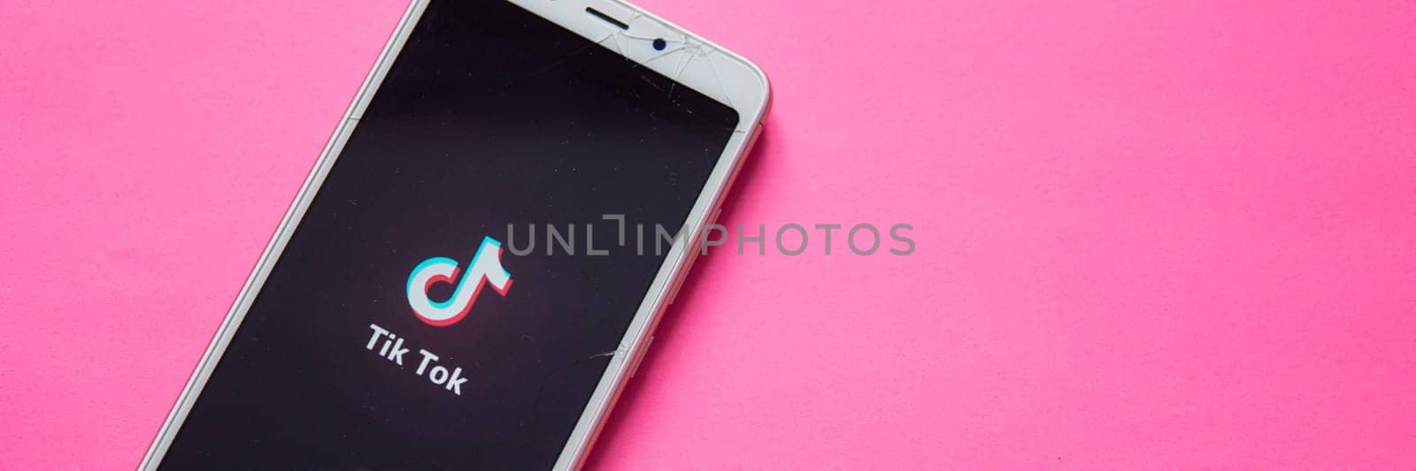 Tver, Russia - February 12, 2020 Tik tok logo on smartphone screen on pink background. Tik Tok icon. tik tok application. Tiktok Social media network. by Annu1tochka