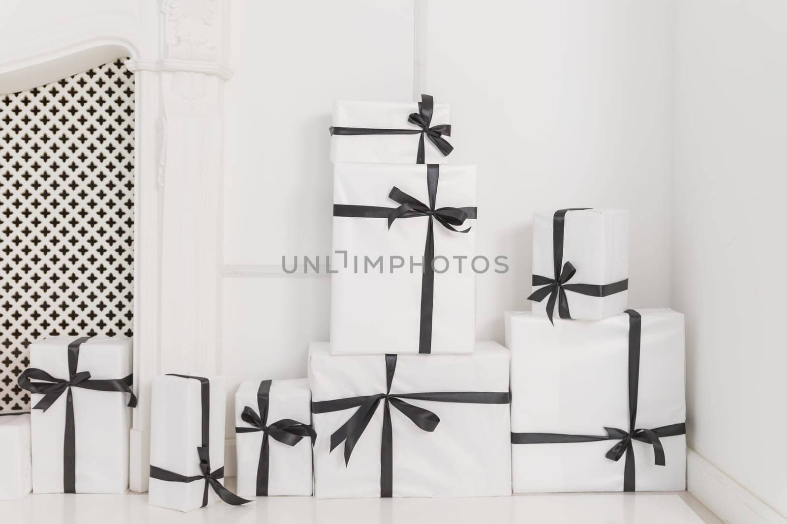 Packaging box studio shot of white boxes wrapping with black ribbon with bowknot on white background. Black Friday sale. shop sale promotion and anniversary celebration concept by YuliaYaspe1979