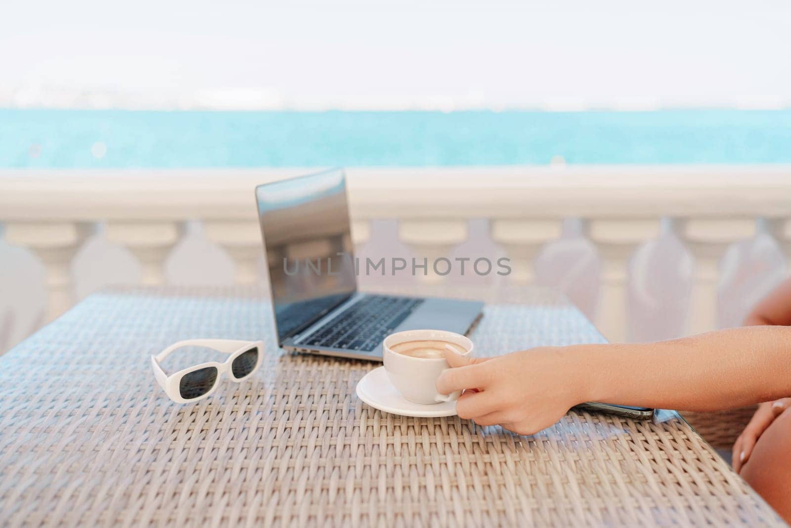 Woman coffee cafe macbook. Woman sitting at a coffee shop with mobile phone drinking coffee and looking away. Caucasian female relaxing at a cafe. by Matiunina