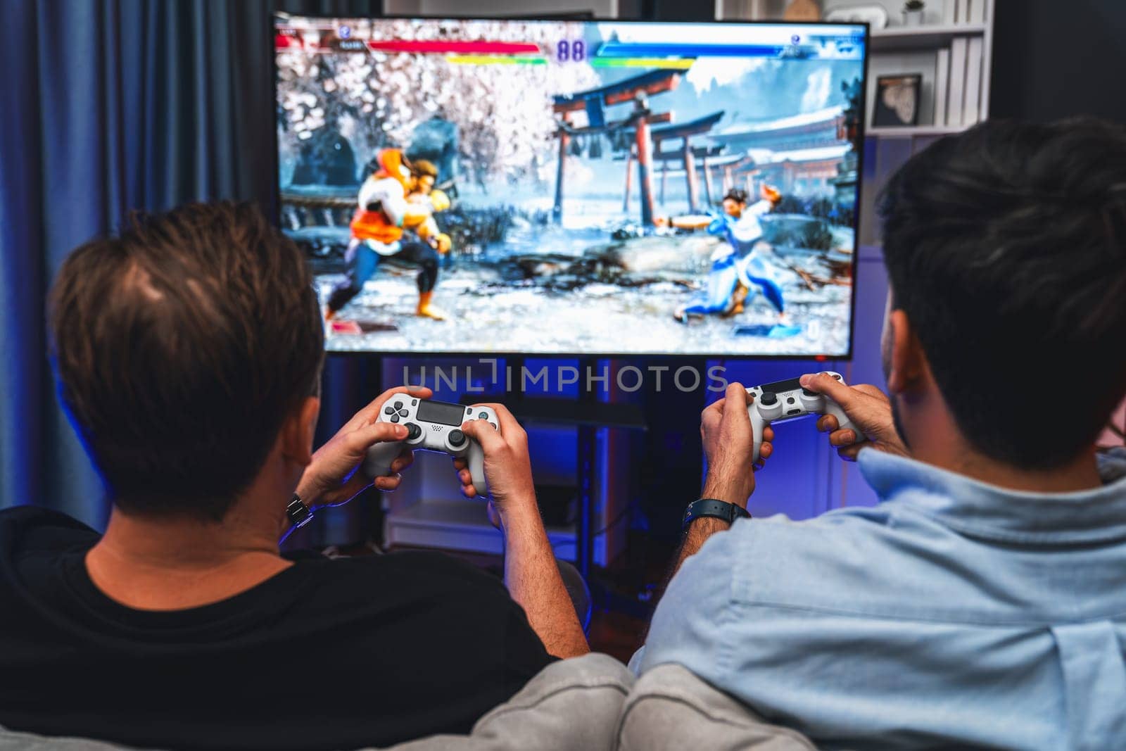 Friend gamers playing video game of battle martial arts fighter. Sellable. by biancoblue