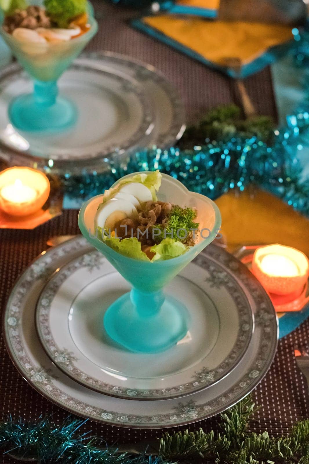 Festively served table, anticipation of Christmas, sea salad in turquoise bowls by KaterinaDalemans