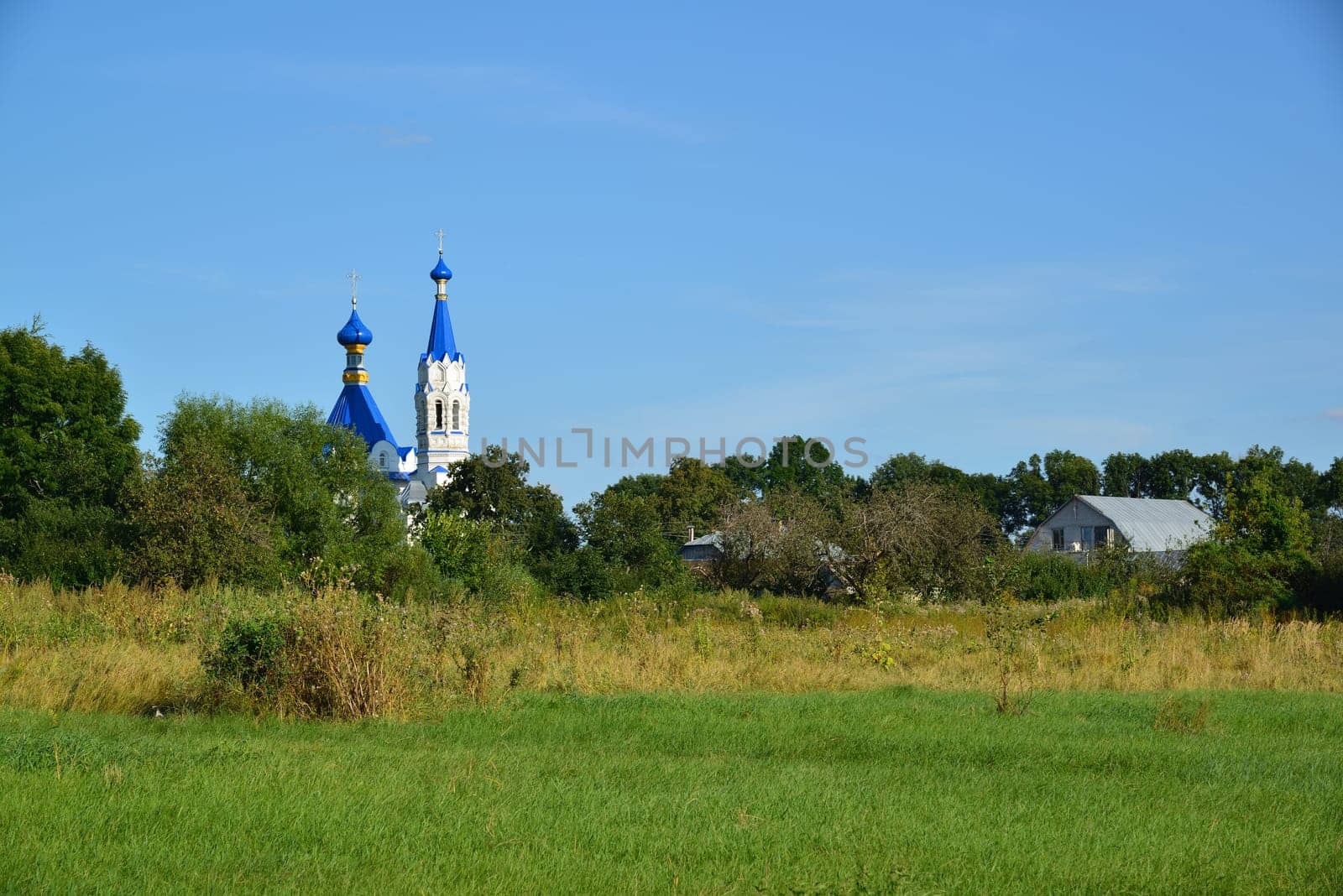 Rural landscape with Church of St. Dmitry Solunsky in the village Korobovka by olgavolodina