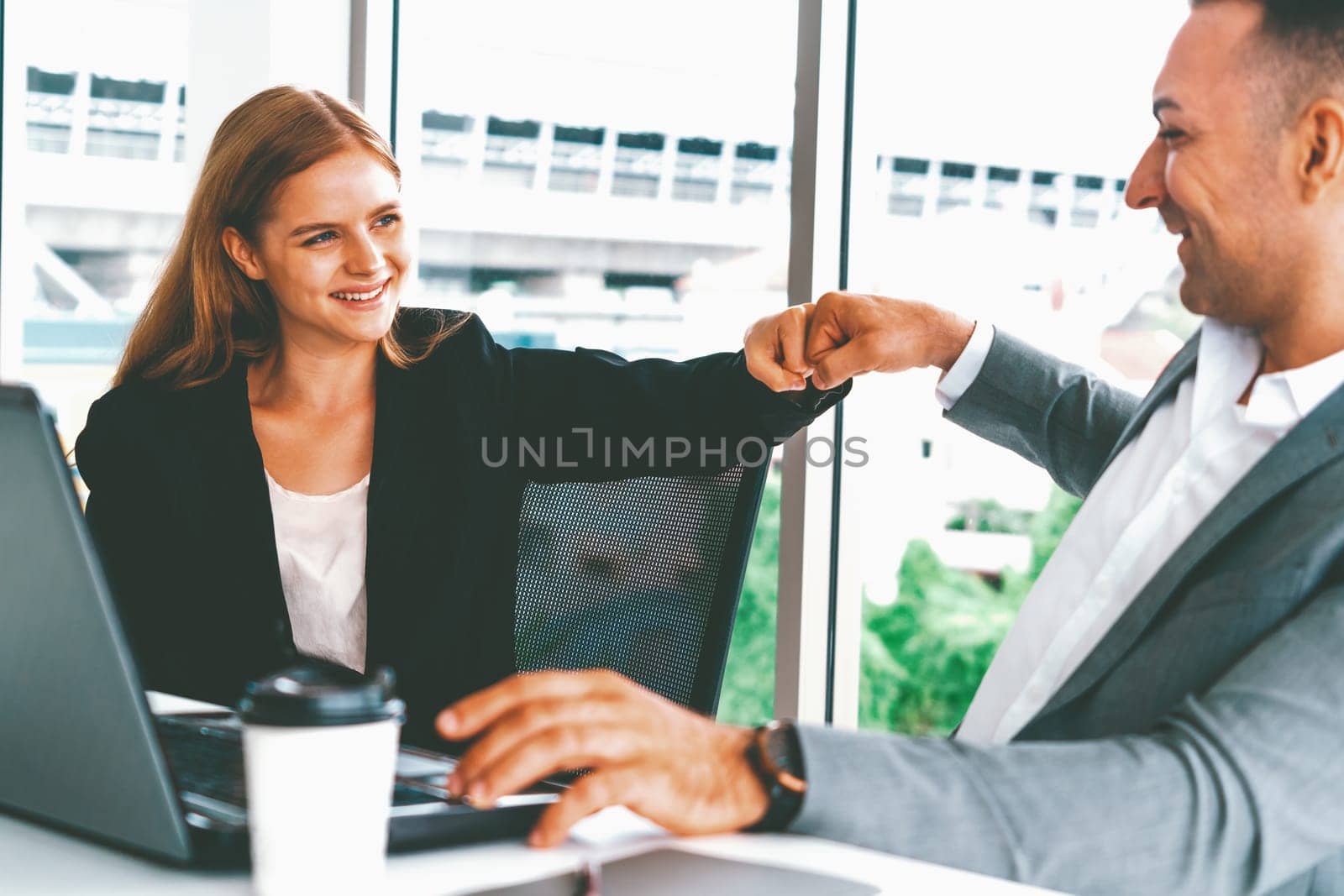 Success business partner - Businesswoman and businessman celebrating together in modern workplace office. People corporate teamwork concept. uds