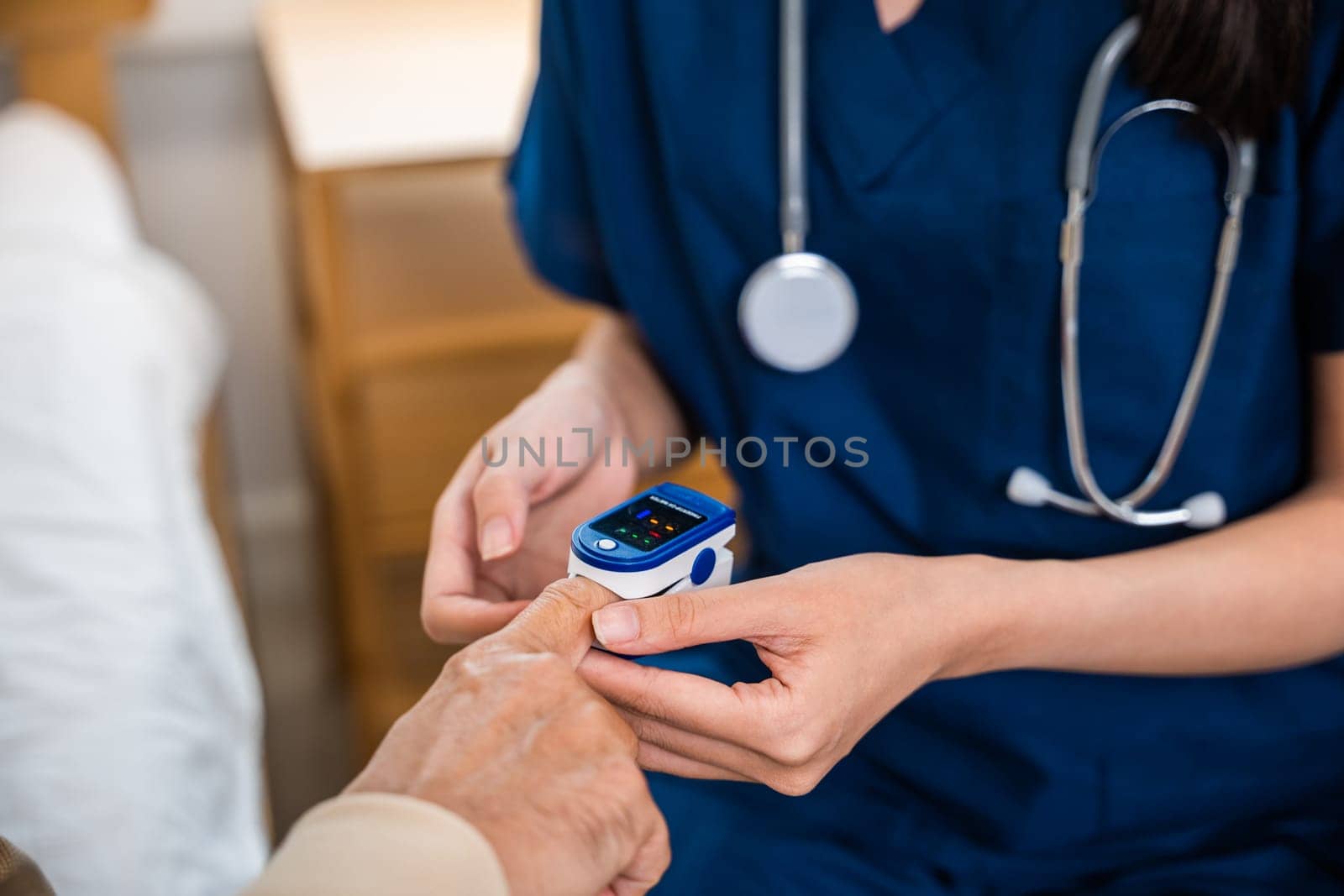 Young woman putting digital oximeter of finger middle aged adult patient man, Asian nurse checking with fingertip pulse oximeter oxygen saturation meter blood monitor finger senior old man at hospital