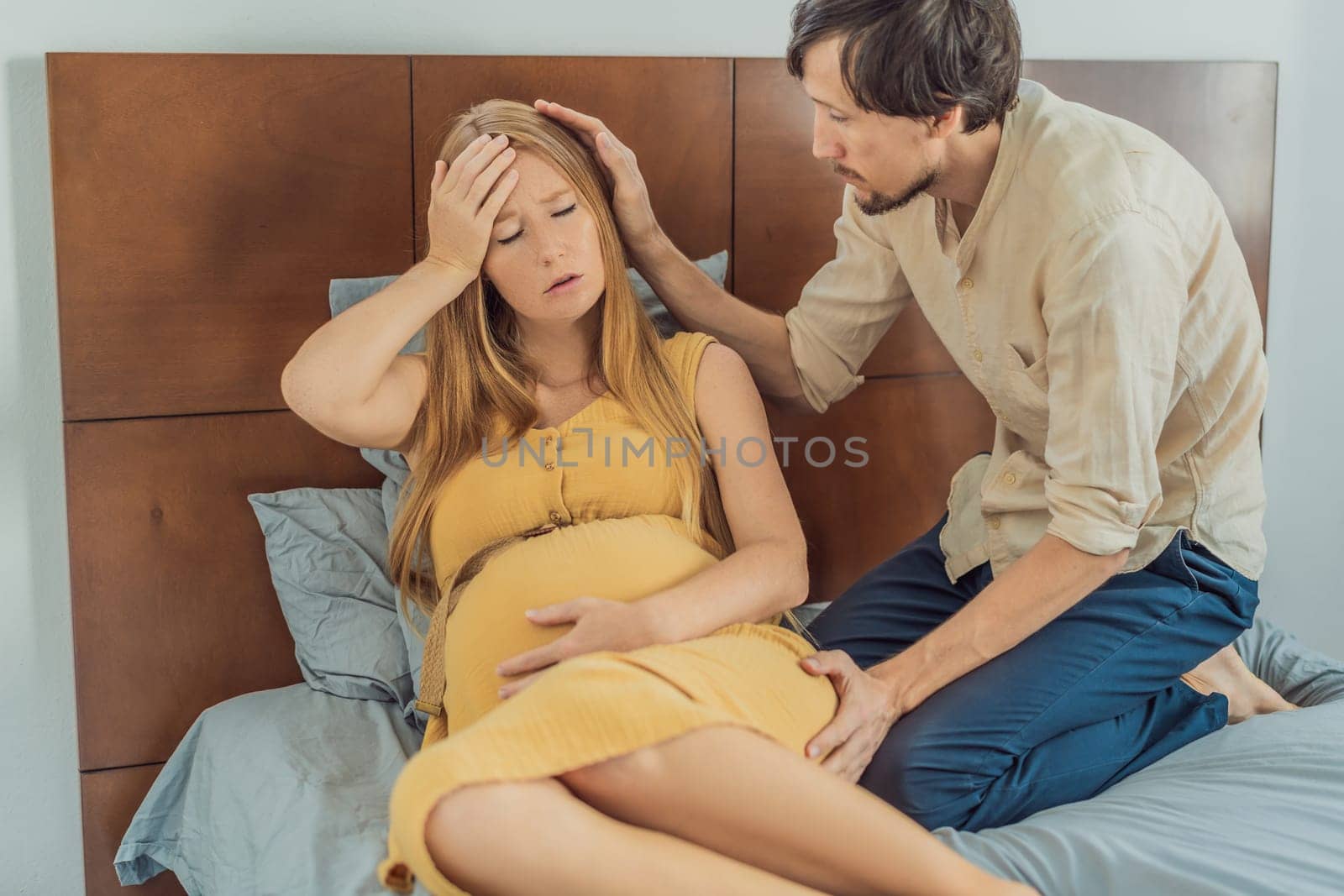 Expectant woman feels unwell, husband comforts and reassures her during a challenging pregnancy by galitskaya