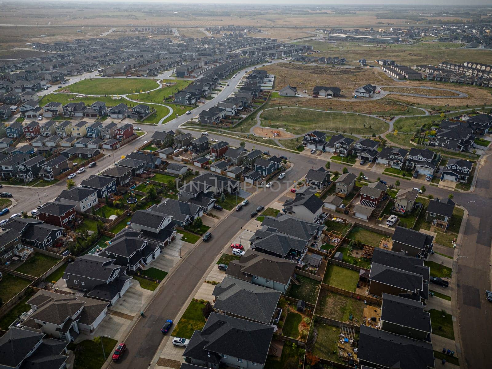 Elevated drone view of Rosewood, Saskatoon, showcasing its residential layout, green areas, and vibrant community life.