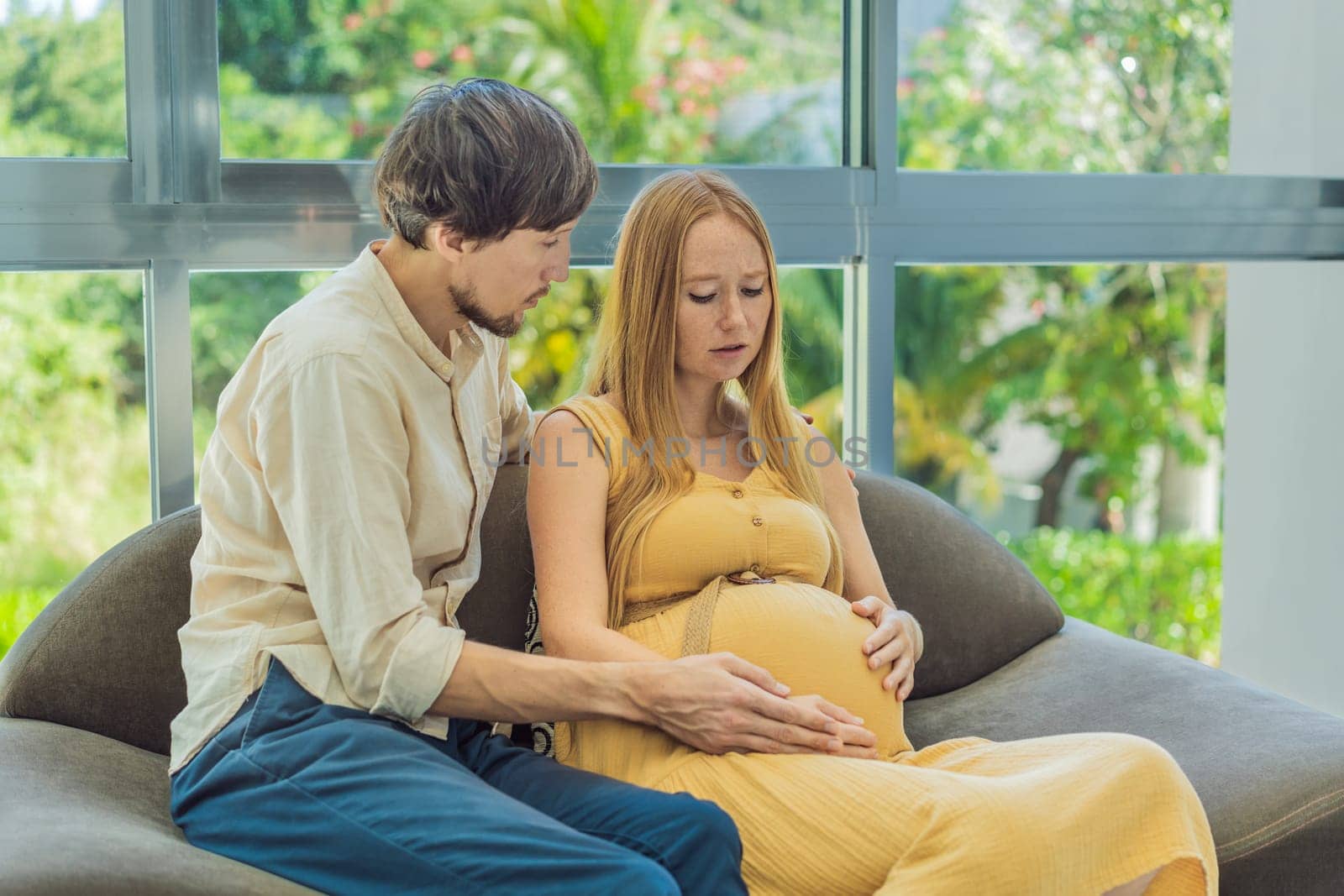 Expectant woman feels unwell, husband comforts and reassures her during a challenging pregnancy.