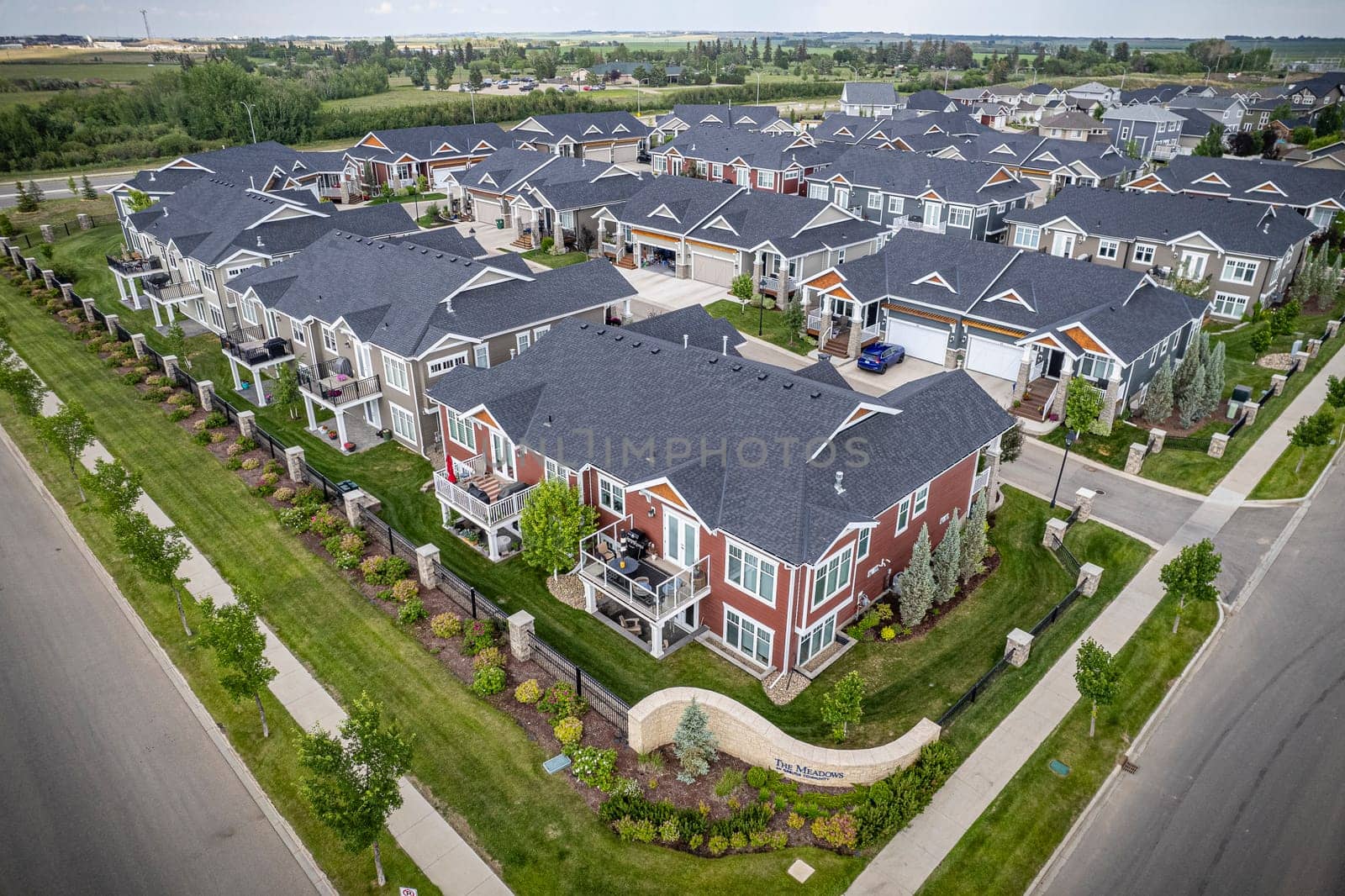 Elevated drone view of Rosewood, Saskatoon, showcasing its residential layout, green areas, and vibrant community life.