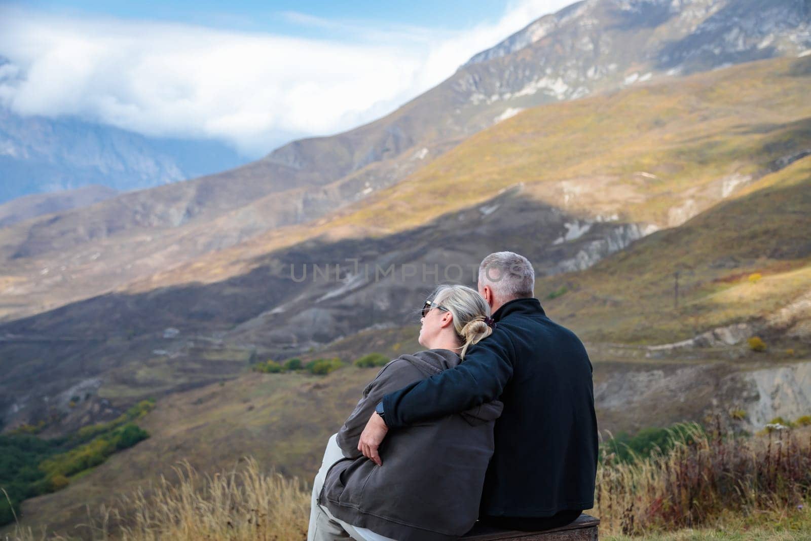 In the mountains, a couple in love enjoying the view of the landscape by Yurich32