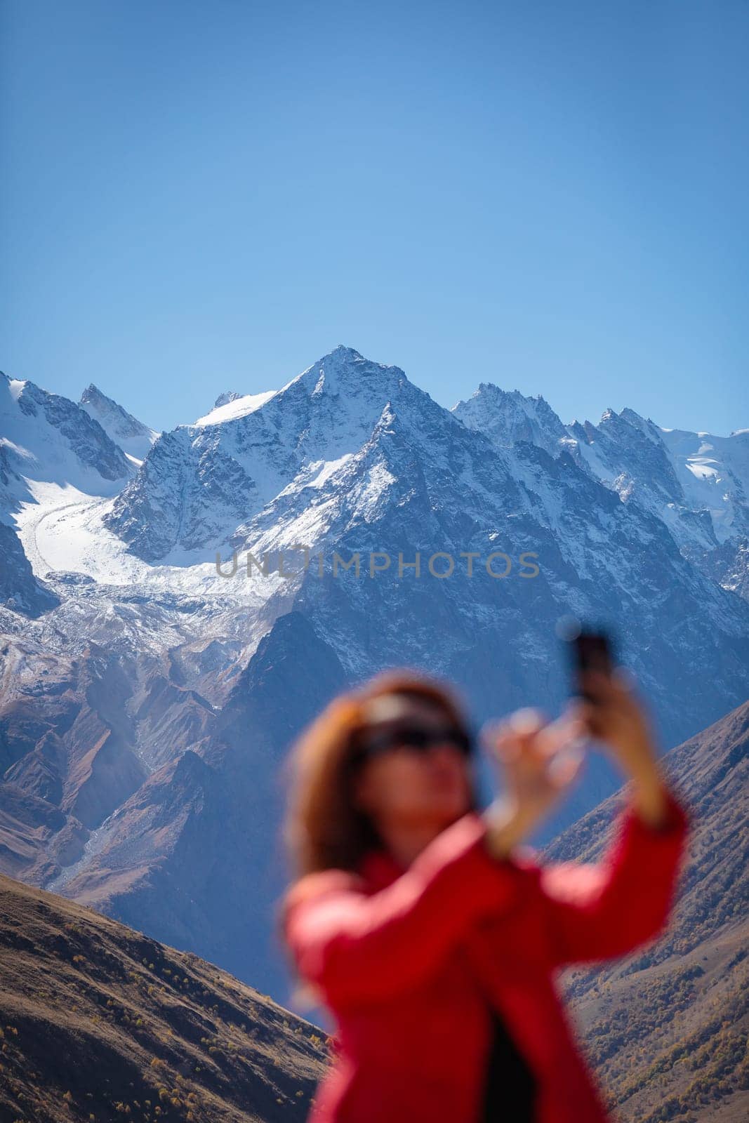 Portrait of a girl against the background of snowy mountains creates a magical mood