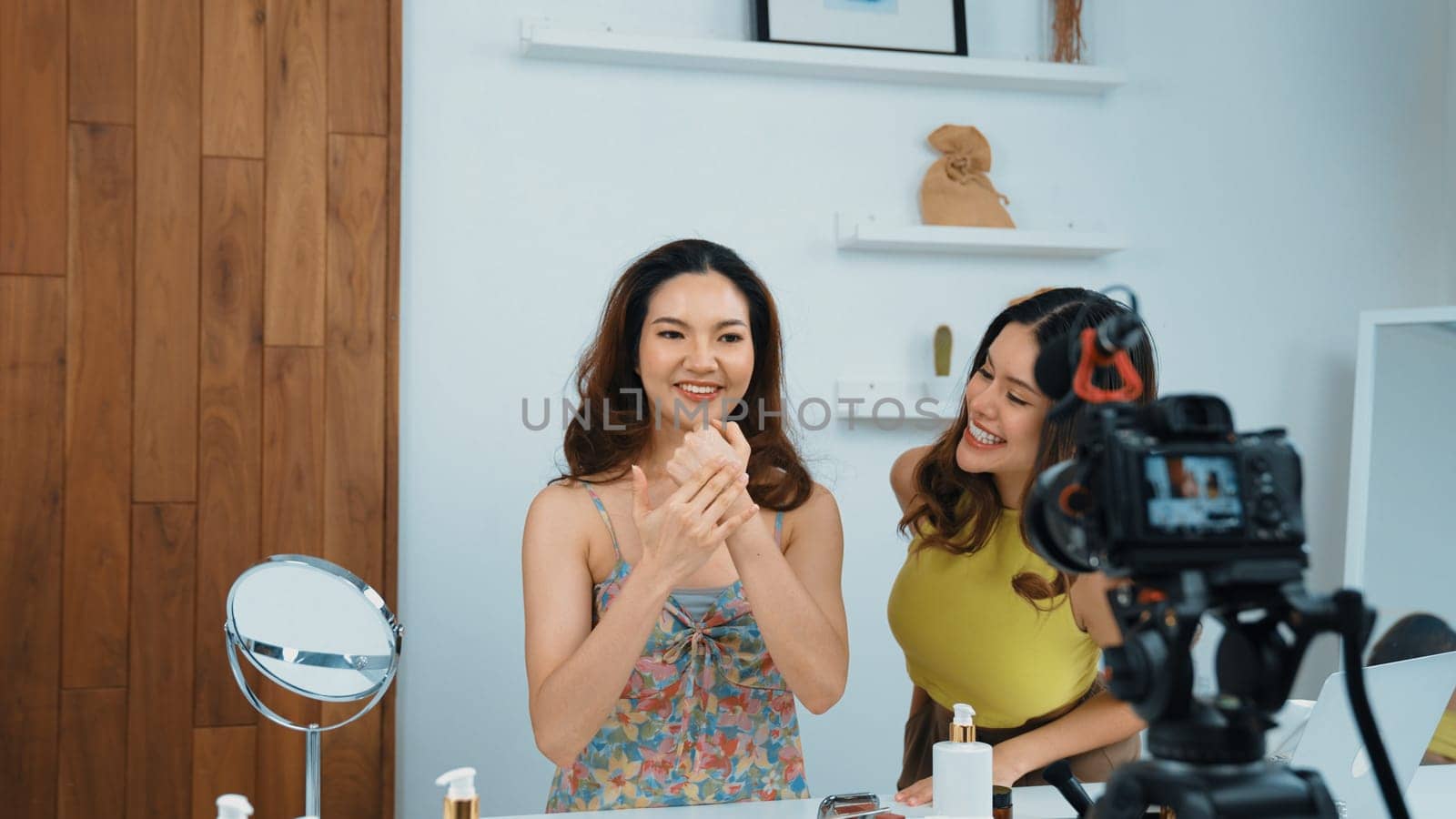 Two women influencer partner shoot live streaming vlog video review skincare for social media or blog. Young girl with vivancy cosmetic studio light for marketing recording session broadcasting online