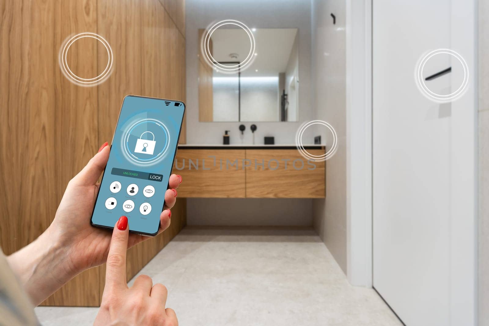 Hand of woman holding smartphone in blurred kitchen with double exposure of smart home interface. Concept of automation