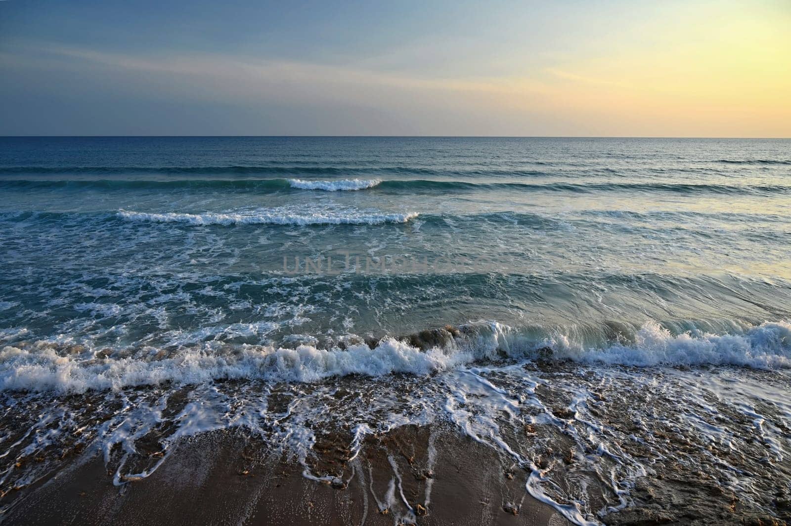 Sea at sunset with waves on the beach. Greece - the island of Corfu. by Montypeter