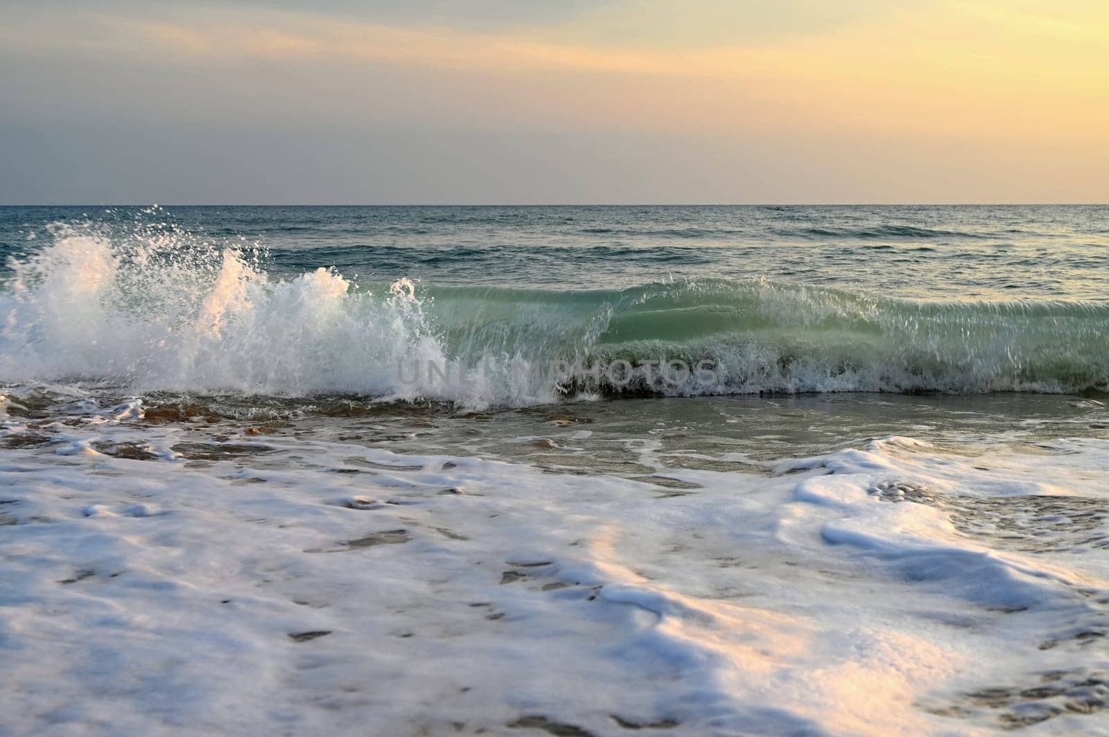 Sea at sunset with waves on the beach. Greece - the island of Corfu. by Montypeter