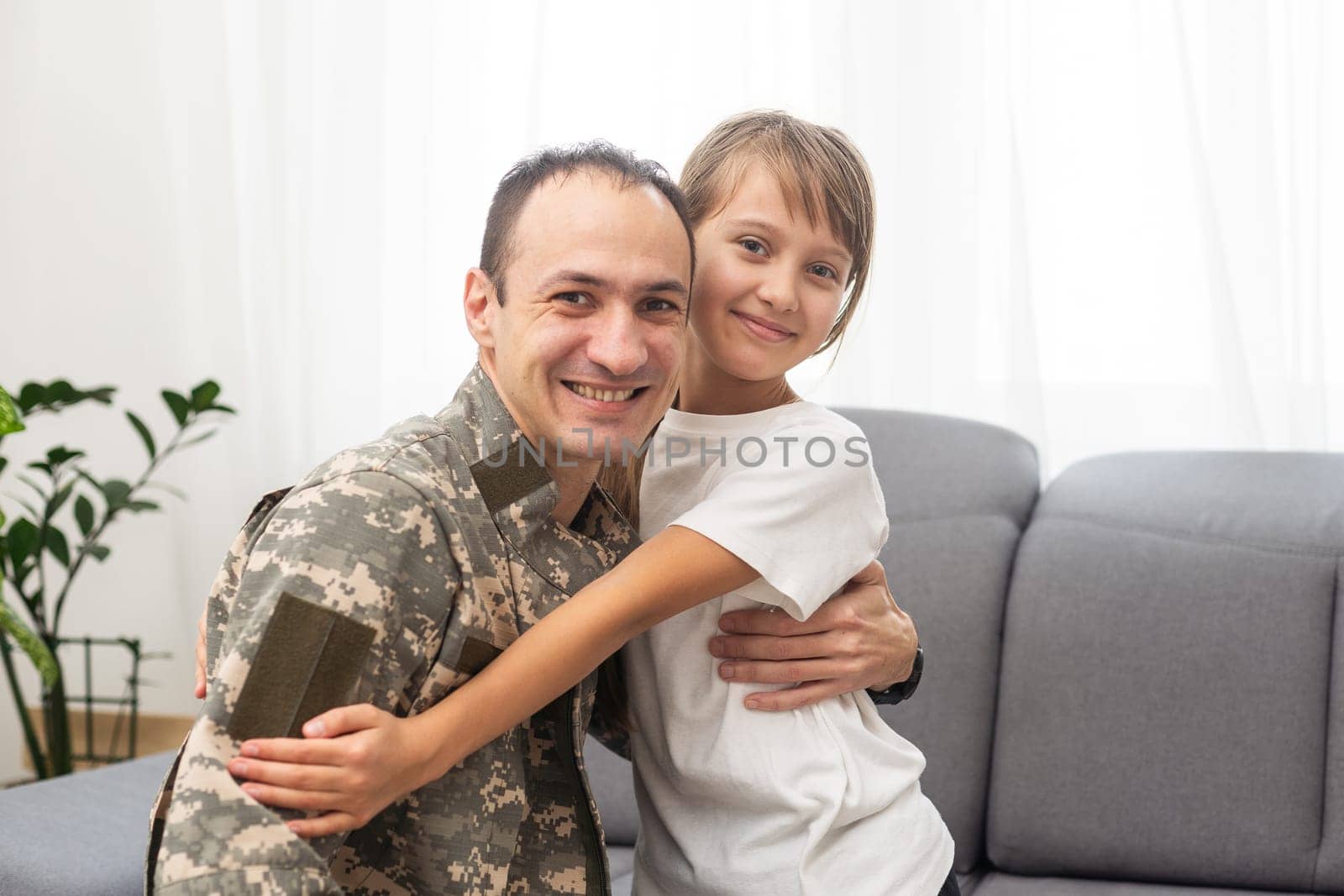 Military dad hugging his daughter. High quality photo