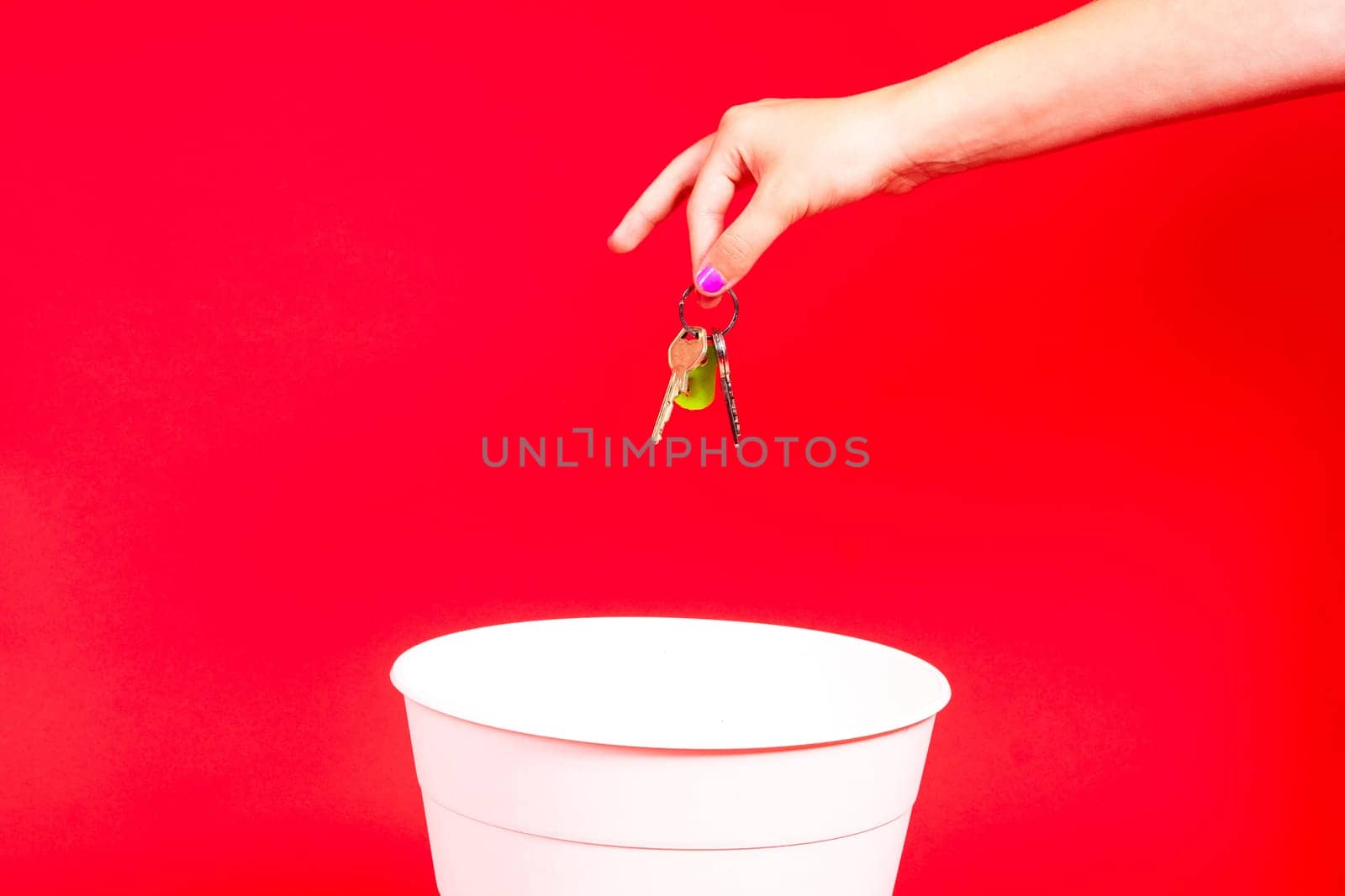 The home keys is thrown into a trash can for disposal and recycling.