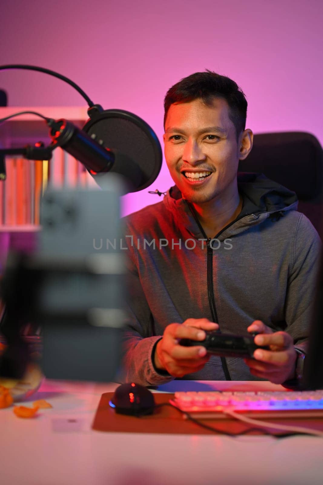 Male gamer playing online video game on his personal computer and talks to other players.