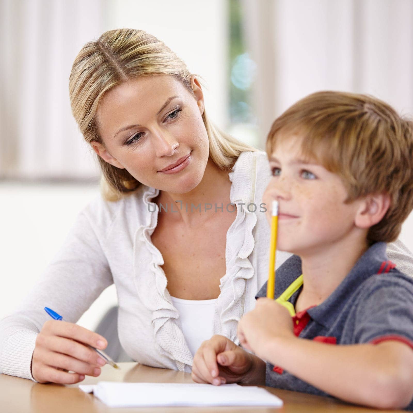 Teacher, student and helping with school work in class, question and think of answer for education and knowledge. Teaching, learn and woman with boy in classroom, study and problem solving for test by YuriArcurs