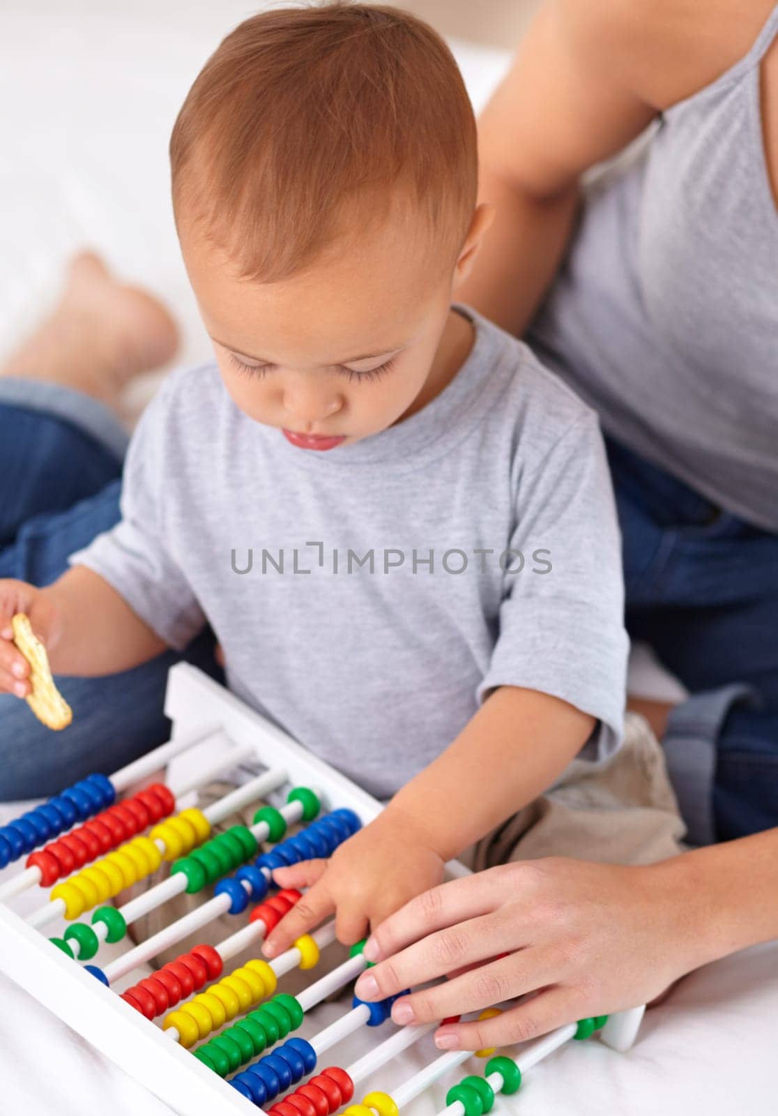 Abacus, toy and baby with mother playing, learning and teaching for child development on bed. Math, bonding and closeup of mom helping kid, infant or toddler with counting in bedroom at home. by YuriArcurs