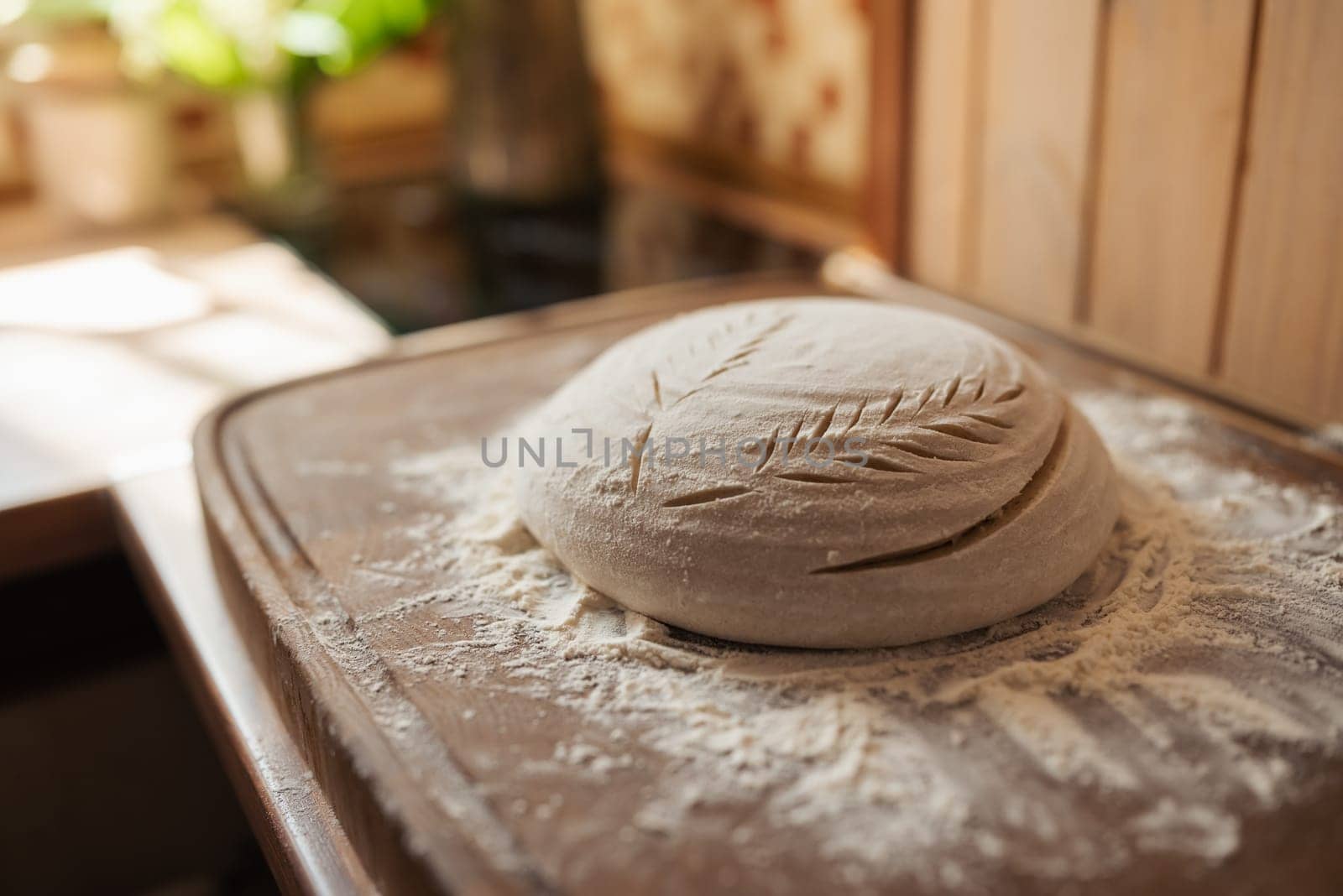 Ready for baking bread dough in flour, ornate with patterns by VitaliiPetrushenko