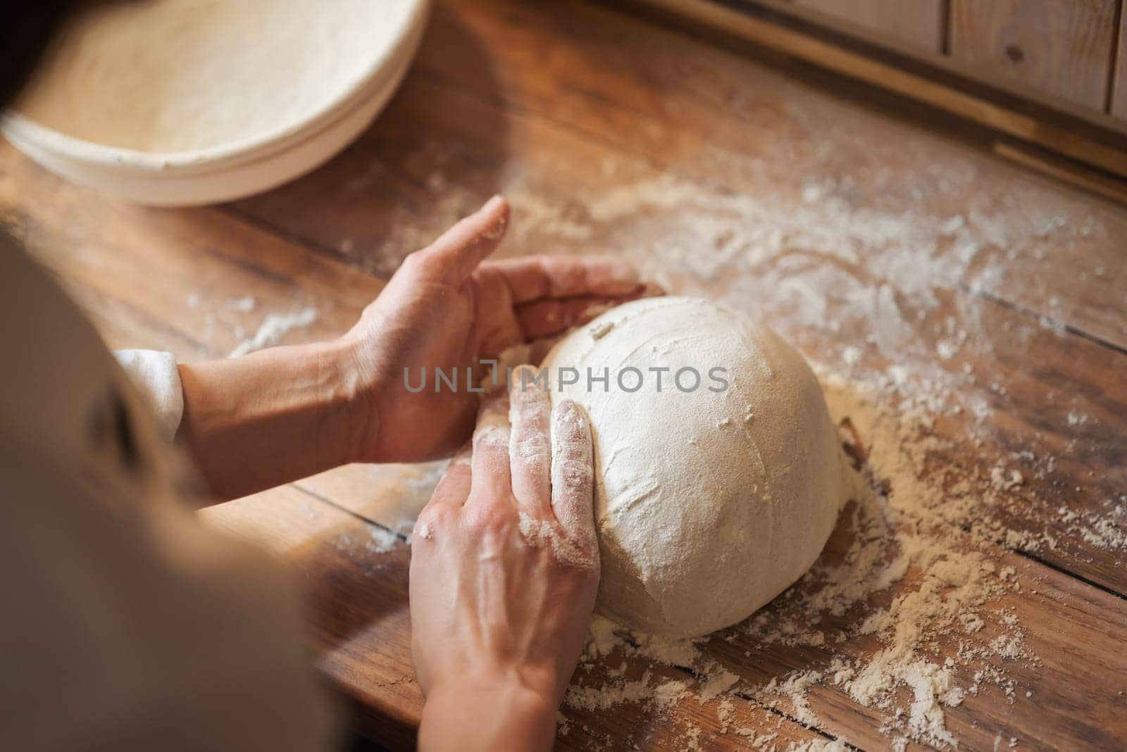 Hands of a girl hostess forming loaf of bread