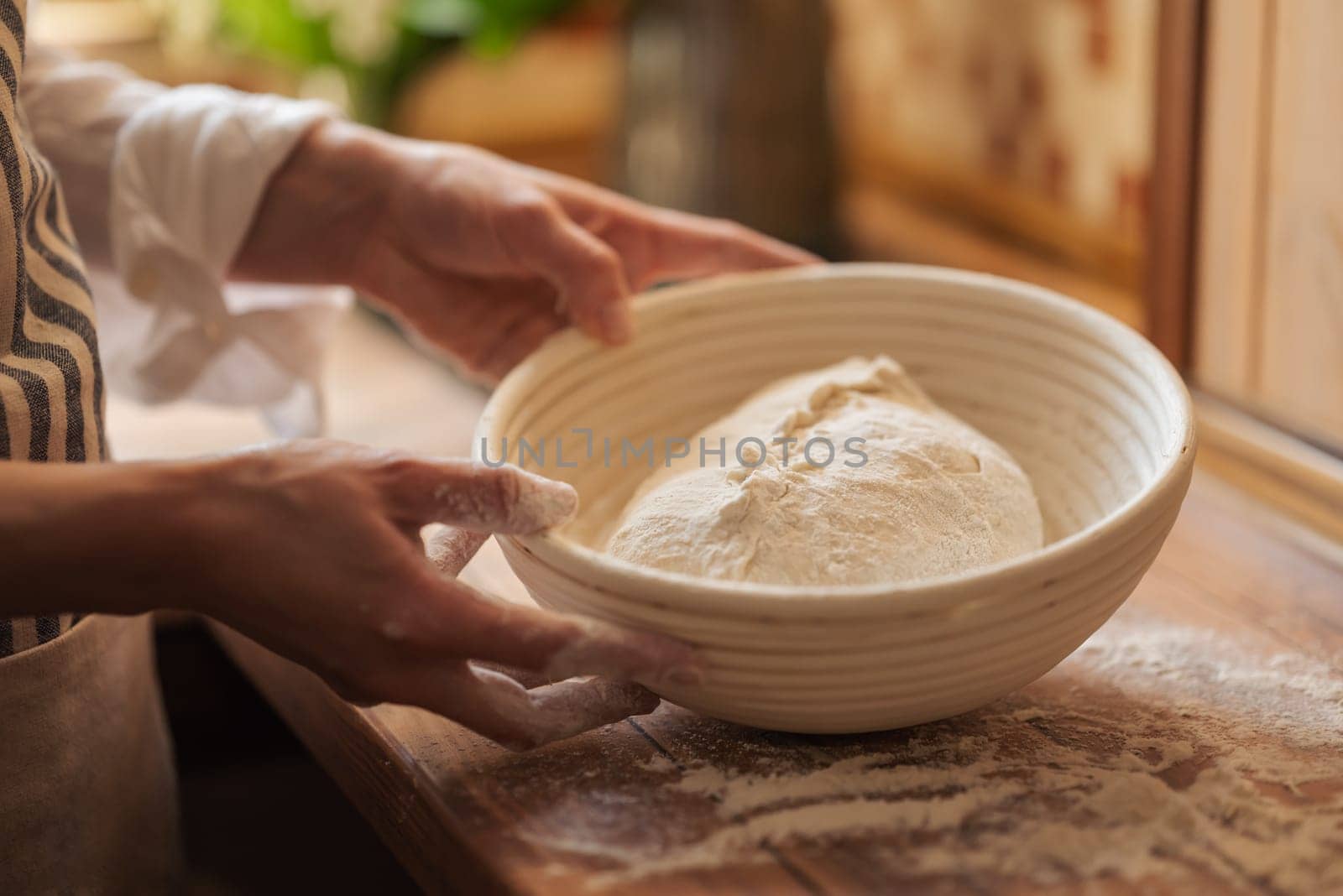 Dough for bread resting in wooden plate