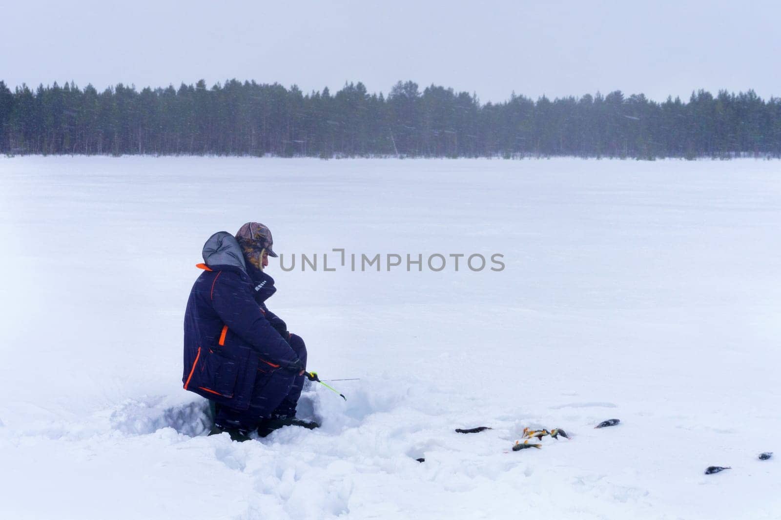 Person holding a small fishing rod in the snow. Selective focus. Copy space by darksoul72