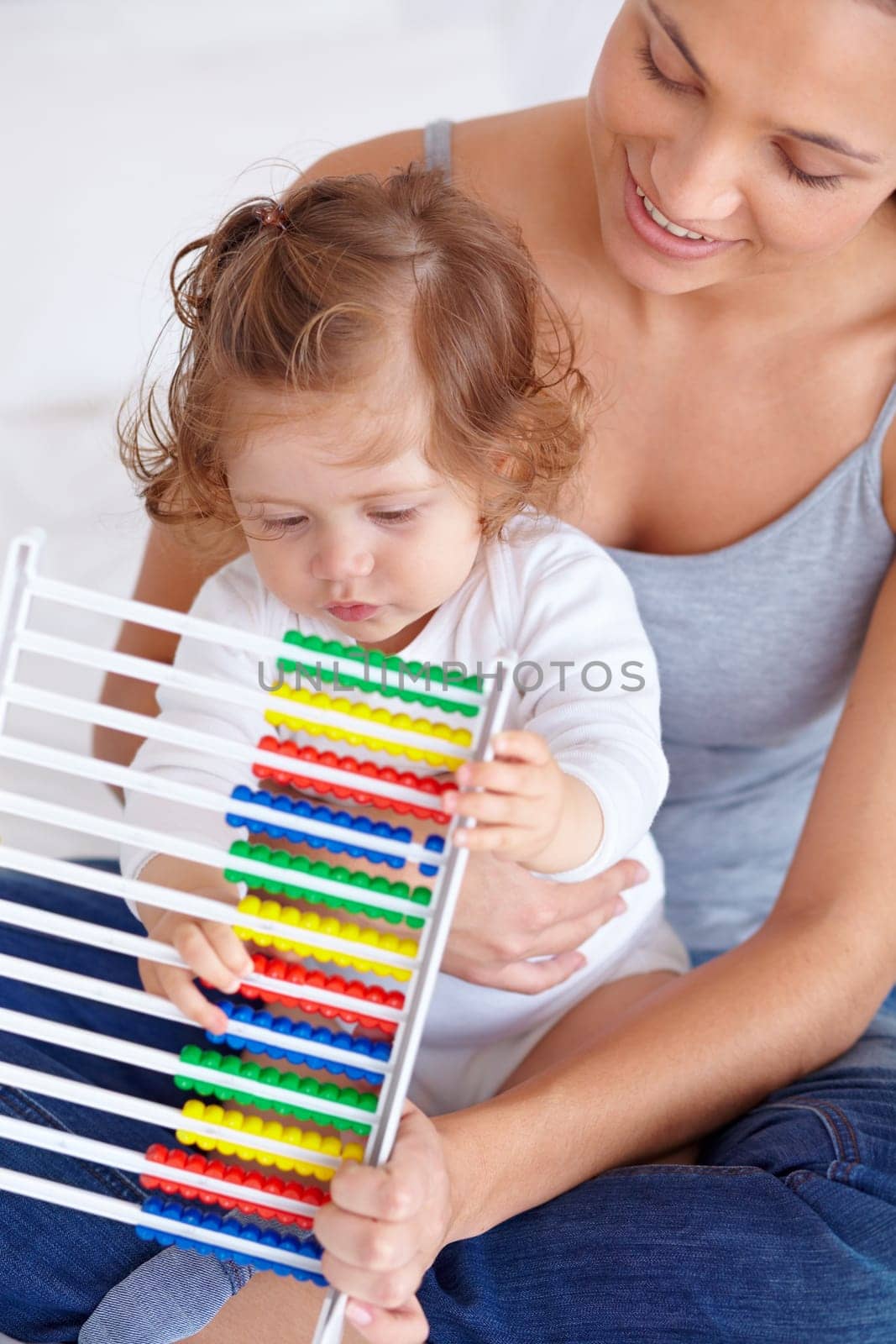 Abacus, education and baby with mother playing, learning and teaching for child development on bed. Bonding, toy and closeup of mom helping kid, infant or toddler with counting in bedroom at home