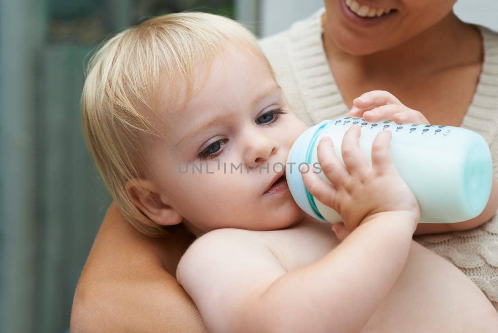 Relax, sweet and baby drinking bottle and laying with mother for milk and bonding together. Cute, growth and infant, kid or toddler enjoying a beverage for nutrition, health and child development