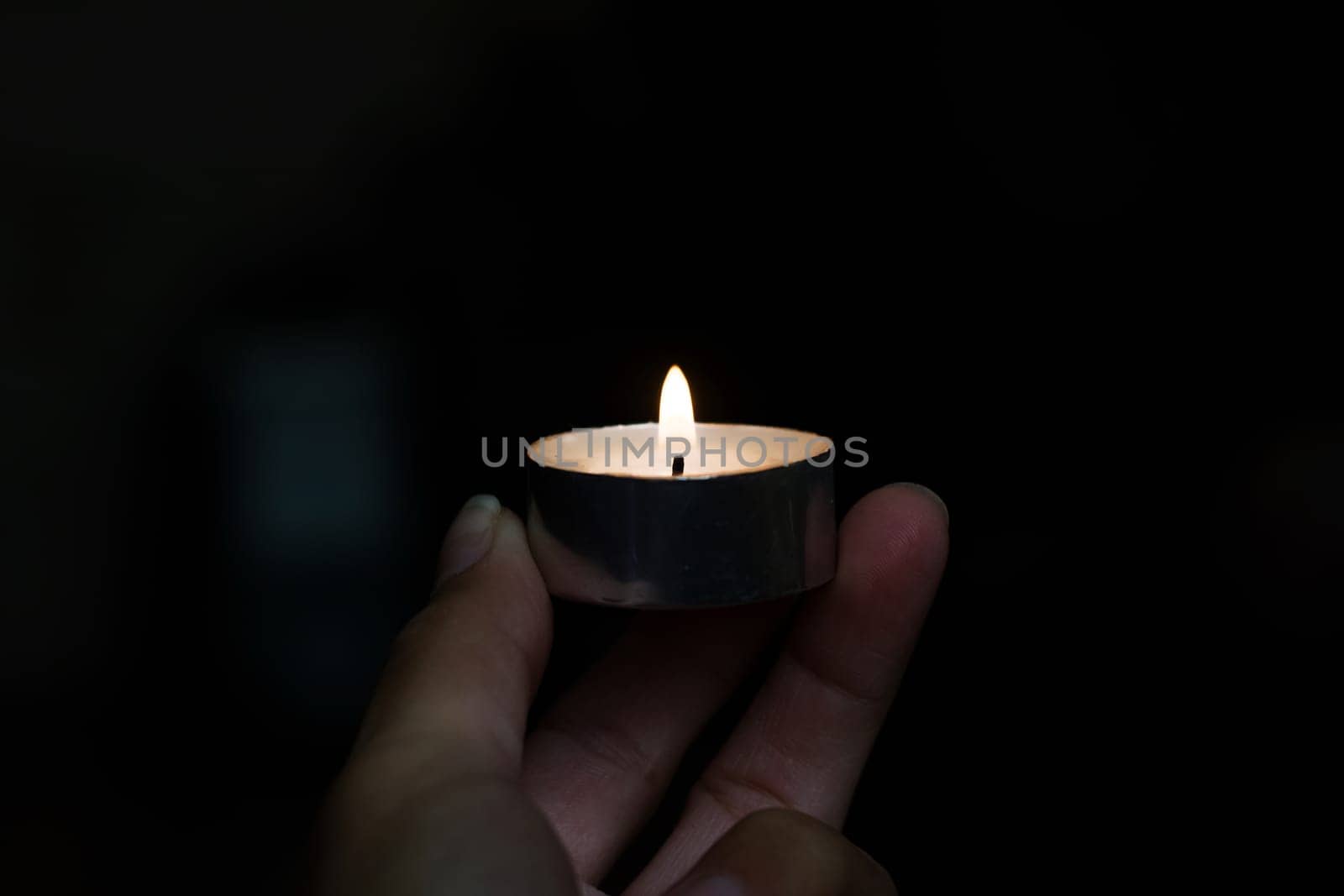 Candle in a hand closeup in the dark by Vera1703