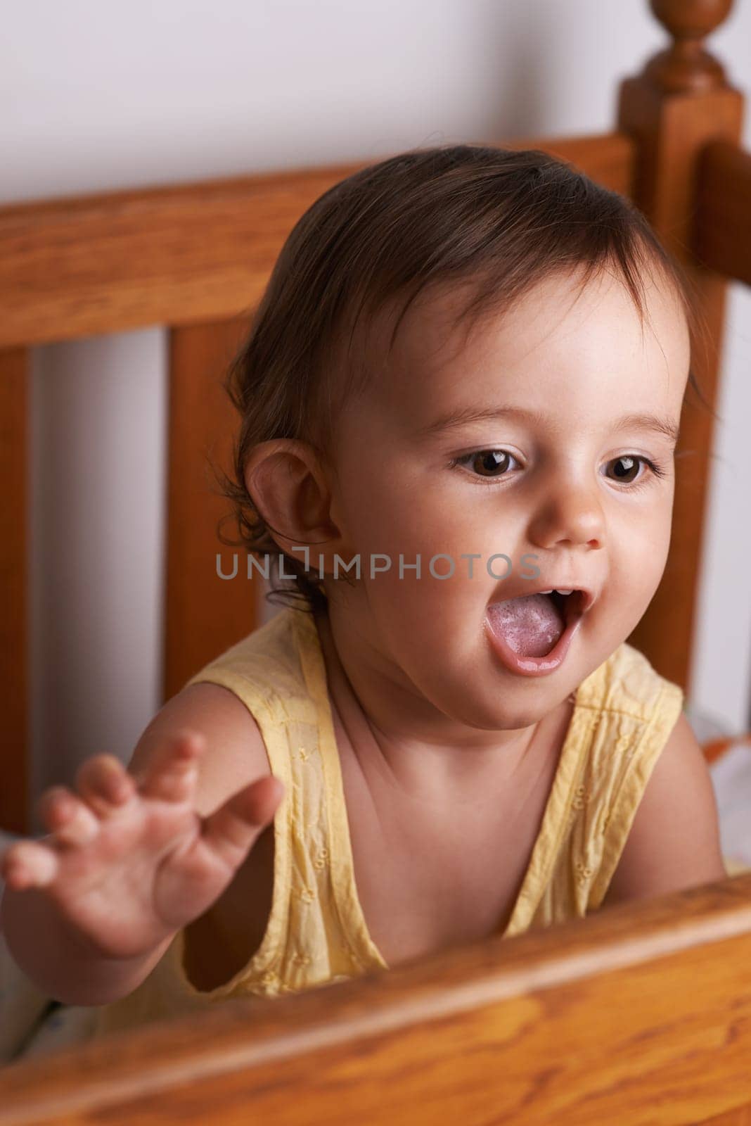 Baby, laughing and crib at home in bedroom with youth, excited and talking with development. Kid, toddler and nursery in a house with smile, happy and curious with morning with sweet and cute girl.